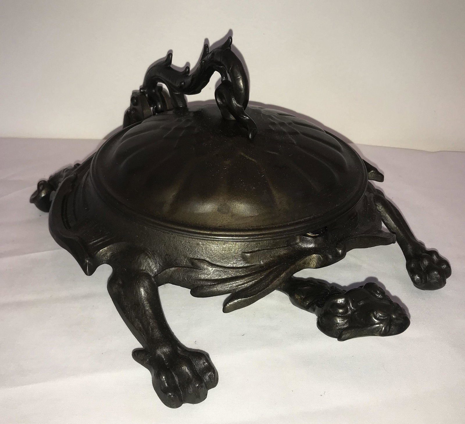 Tortoise Form Spittoon: Cast iron tortoise form spittoon, hinged lid operated from head opens to original iron pan (pan showing old wear), marked on undeside II 3612, approx. 5 1/2" T x 9" W x 11 1/4" D