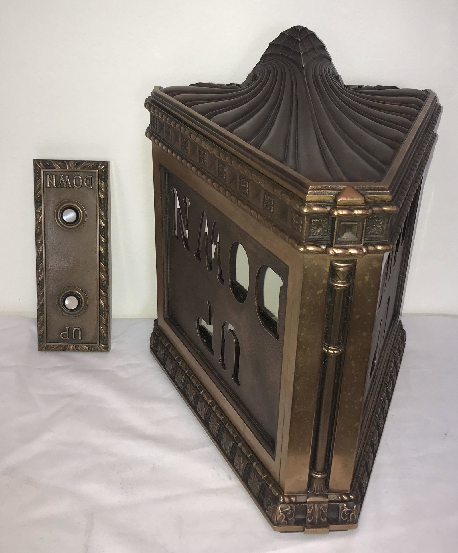 Vintage Elevator UP/DOWN Sign: Vintage ornate bronze elevator tri-corner wall mounted UP/DOWN sign w/fleur de lis and rope twist, flower petal design; transluscent glass letters-missing (1) O and (1) N; 2 later blue stained glass p