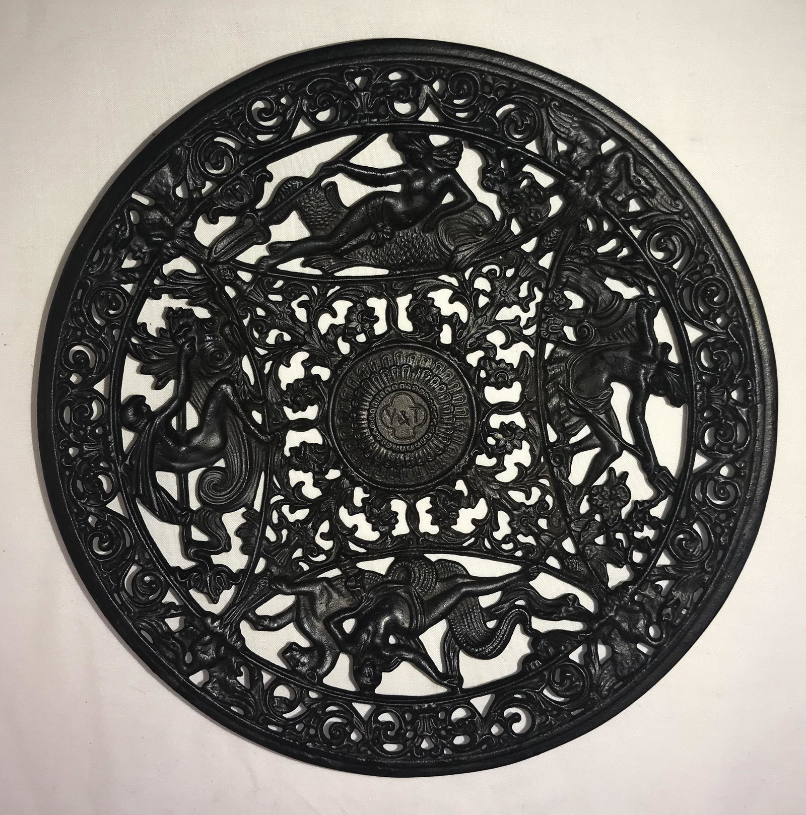 Reticulated Business Card Tray: Cast iron round reticulated business card tray, painted black w/ornate figural design w/mermaid and fish, nude w/serpent, man w/fork and urn, man w/spear on a fish, center initial Y&T, marked Yale Loc
