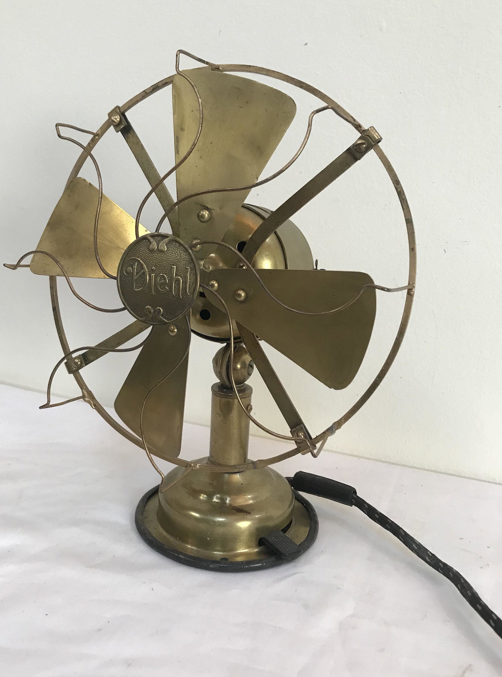 Diehl Brass Electric Fan: Vintage brass electric fan marked Diehl Manufacting Co, Elizabethport, NJ, style no. 0128, sn261015, 3 speeds, w/original old style cord, adjustable angle; approx. 11" T x fan guard 8 3/4" diameter - 