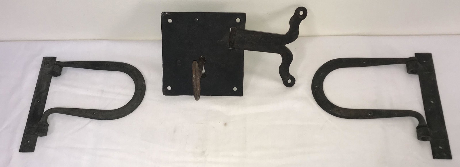 Wrought Iron Lock and Hinges: Wrought iron grouping: a square door lock w/key and latch; (2) "horseshoe" form hinges; door lock-5 5/8" square , latch-5 1/4" L x 5 1/2" T; hinges-7 7/8" T x 8 1/4" W