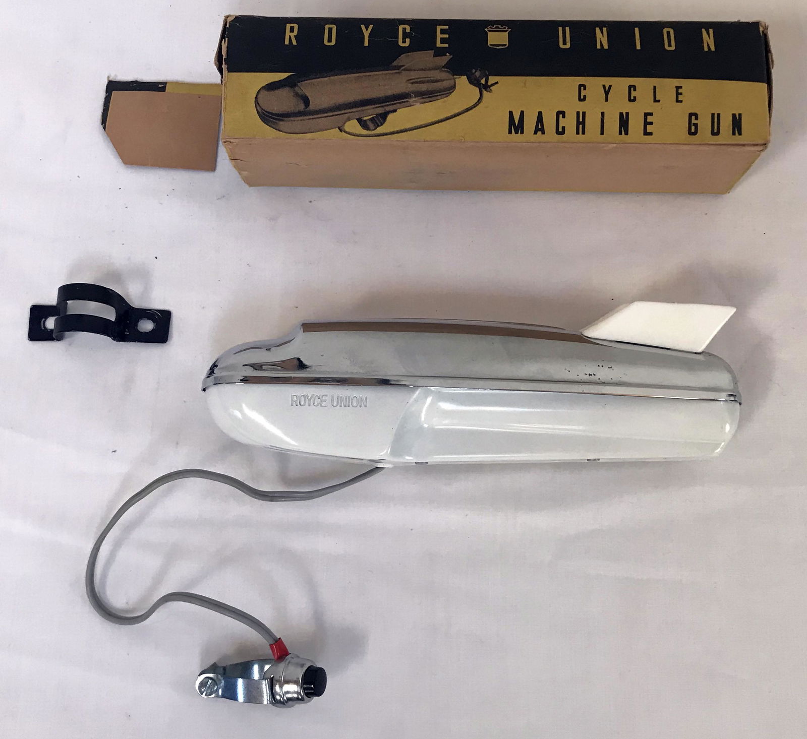 Electric Cycle Machine Gun: Electric Cycle Machine Gun made by Royce Union, Model 902 w/original black and yellow box; gun w/chrome plated top, white metal base and plastic fins, cord and button; appears to have little if any us