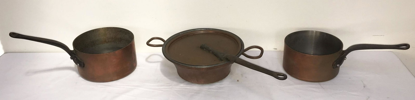 3 Copper Cooking Pieces: Grouping of 2 similar later copper pots w/iron handles, marked France, 4 1/2" T x 8" diameter, handle 7 3/4" L; 4" T x 7 1/4" diameter, handle 7 1/4" L AND a copper collander w/copper handles, galvini