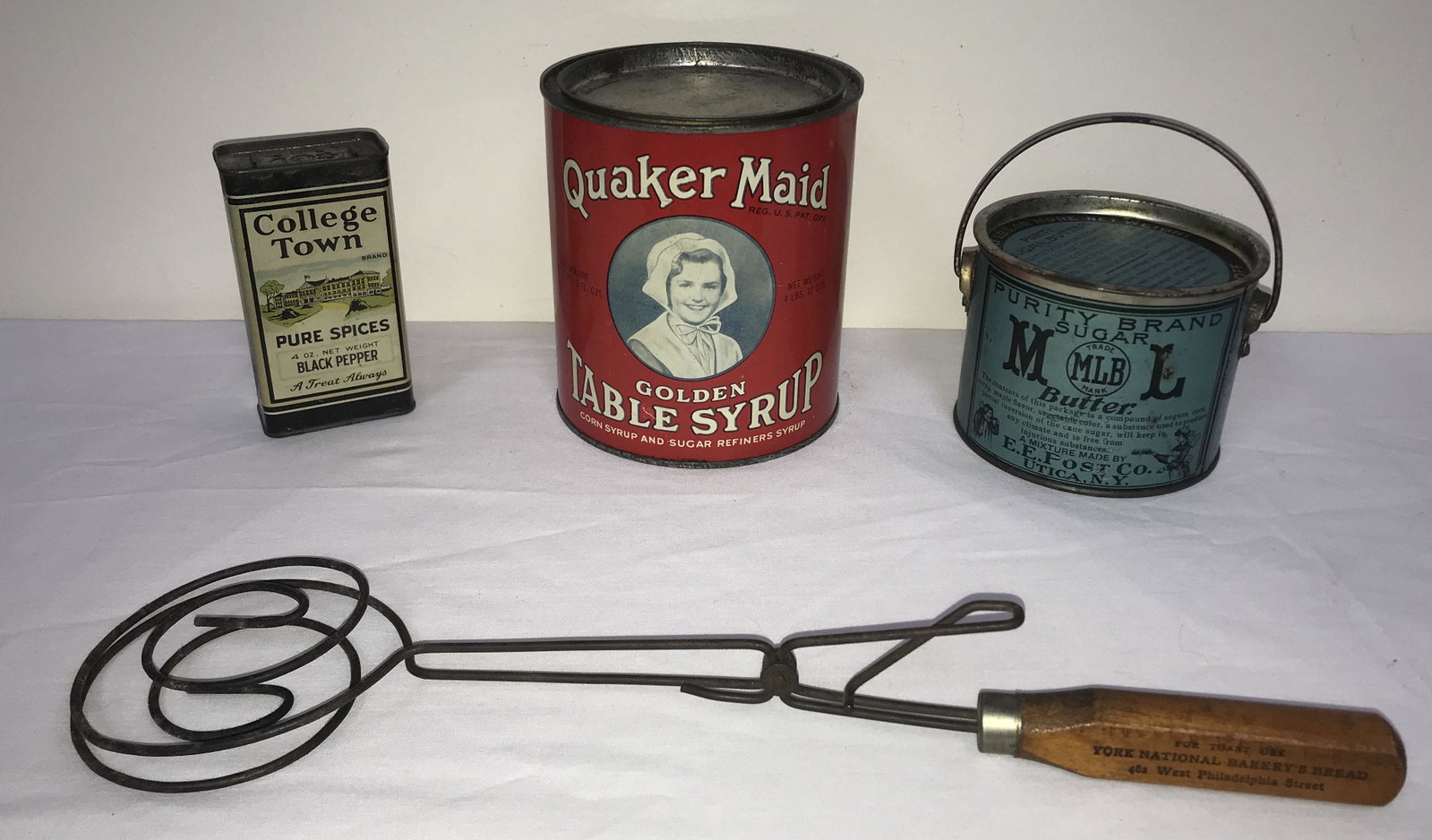 Vintage Advertising Grouping Lot of 4 Pieces: Vintage advertising grouping/lot-4 pieces: tin Quaker Maid Gold Table Syrup w/lid, 5 5/8" T x 5 1/8" diameter; MLB, Purity Brand Sugar Butter tin w/lid and wire swing handle, 3 1/3" T x 4 1/2" diamete