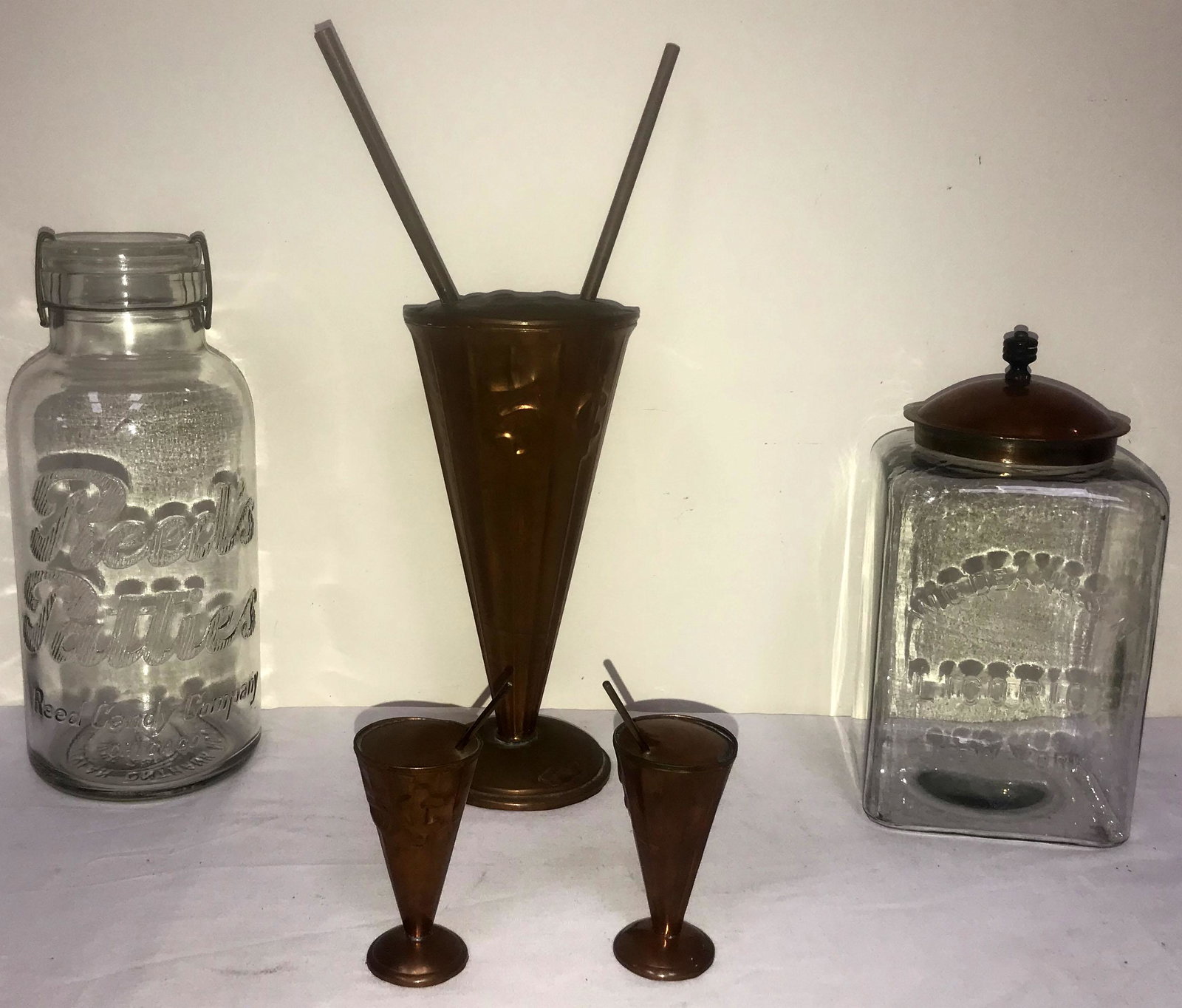 Grouping of Ice Cream/Candy Shop Collectibles: Grouping of ice cream parlor/candy shop collectibles: clear glass jar advertising W.G. Dean & Son Licorice, New York w/copper lid, 10 1/4" T x 5" square; clear glass jar w/Kant Krack lid w/brass wire 