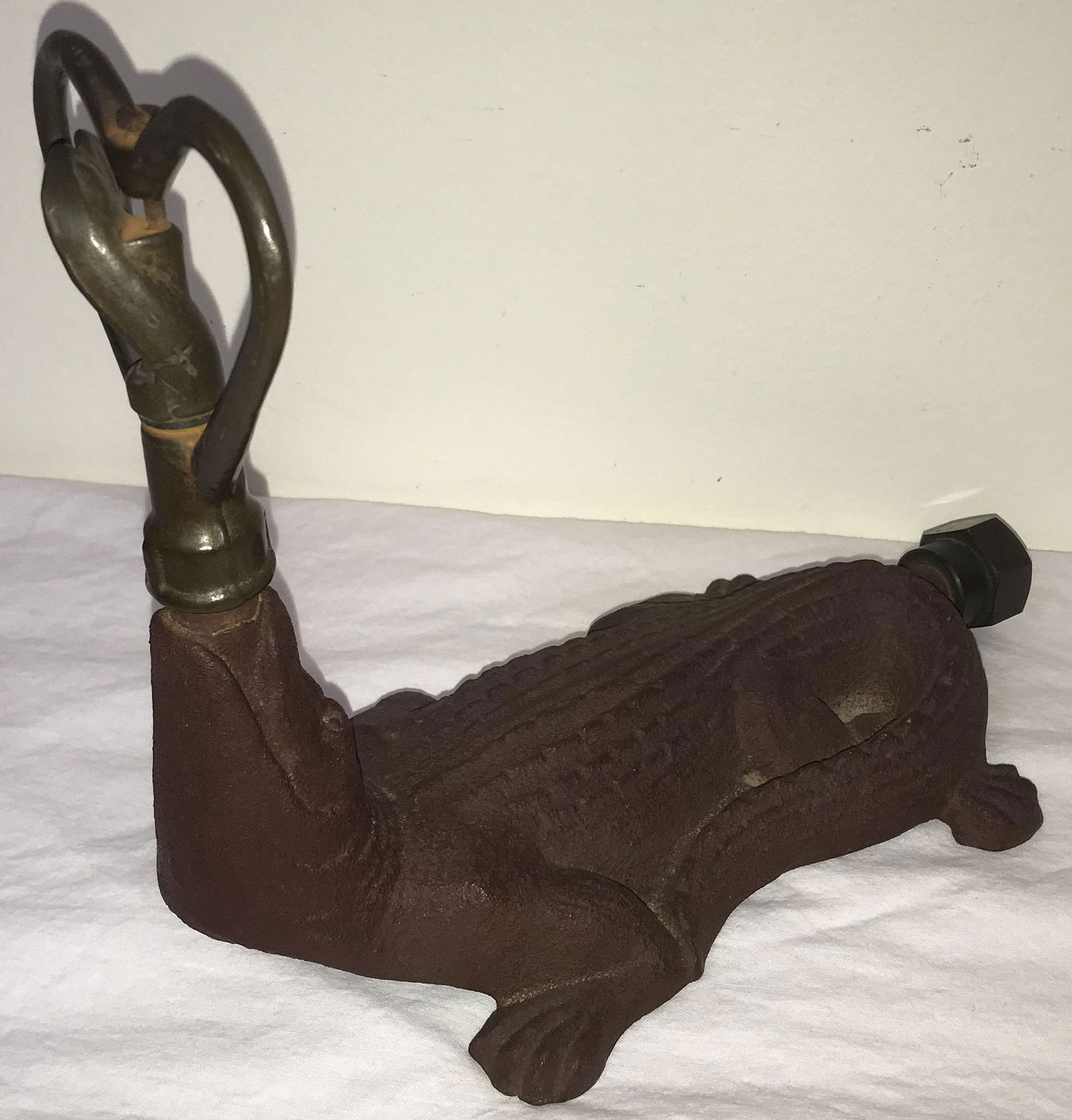 Vintage Cast Iron Sprinkler: Vintage cast iron alligator form sprinkler w/heart shaped brass sprinkling attachment and hose coupling, reddish/brown finish, 8 1/2" T x 10 1/2" L x 5 3/8" W,