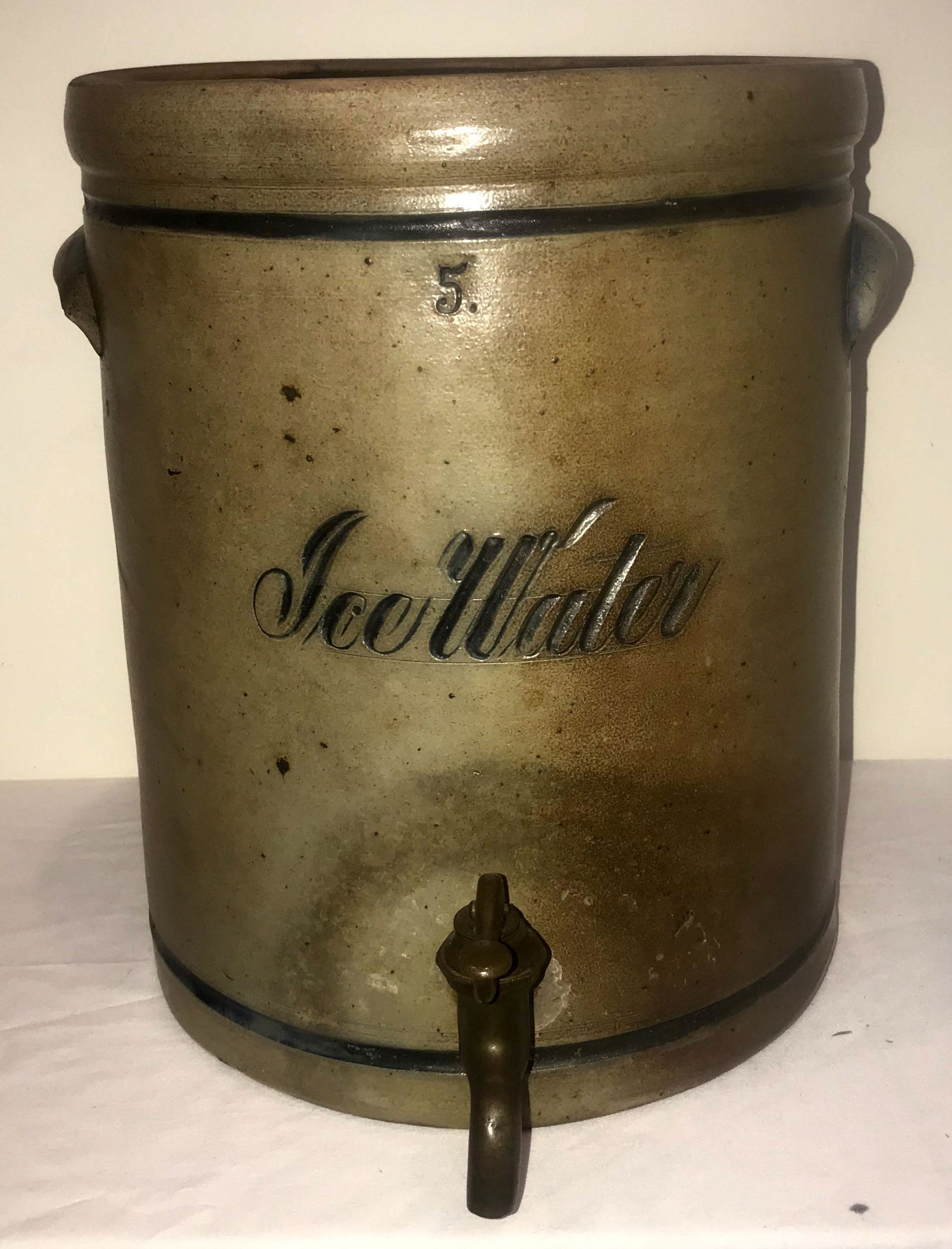 Antique Blue Decorated Stone Water Container: Antique blue decorated gray stoneware 5 gallon ice water container w/brass tap, double handled, no lid, some surface wear, glaze chipping and gouges visible, 14" T x 11 1/8" diameter