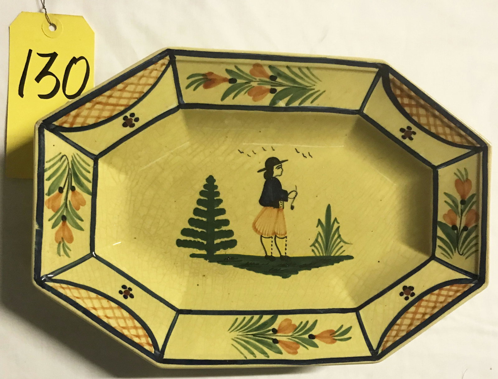 Quimper Pottery Octagonal Platter: Quimper French pottery octagonal platter, rim decorated w/flowers and lattice work design, center landscape scene w/young man standing, good overall condition, crazing visible, marked HB, 12 1/2" x 8 