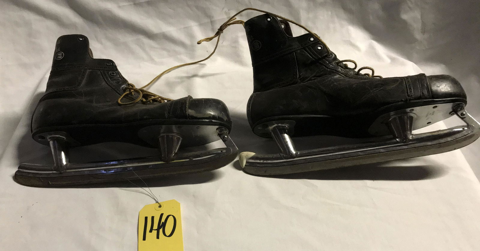 Vintage Men's Ice Skates: Pair of vintage black leather men's ice skates marked C.C.M. Bobby Hull, Pro OK'd made in Canada, size 13; boots show old wear and scuffing, blades show wear and rust, each 11" T x 14" L