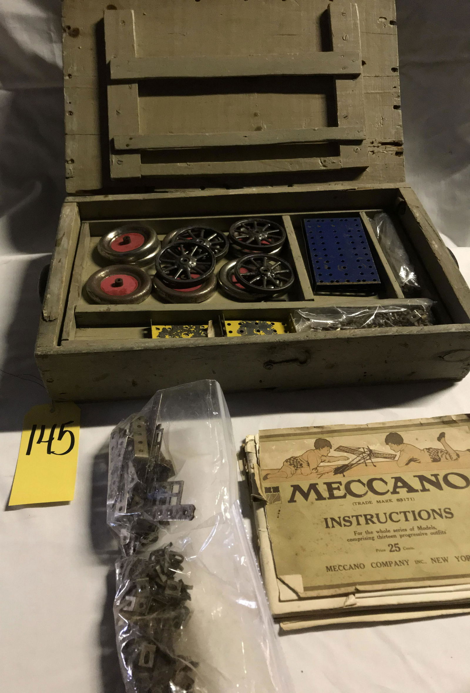 Vintage Model Toy Set-Meccano: Vintage antique model toy set w/Meccano instruction booket incl: variety of parts, pieces, brass, hardware and wheels, etc. in primitive wooden crate; also includes an erector set brochure. Whether or