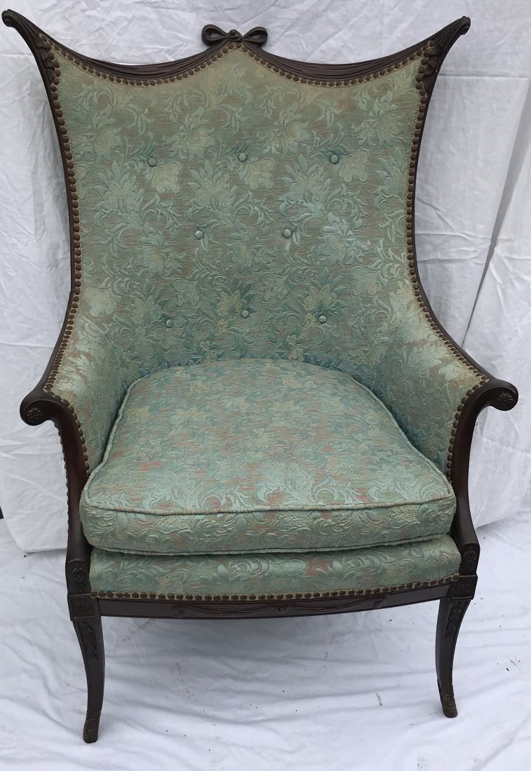 20th C Machine Carved Upholstered Armchair: 20th century machine carved upholstered arm chair crest w/"bow" form carving and scrolled corners on square tapered legs w/rosette and leaf design bluish, green, red and yellow, tapestry upholstery sh