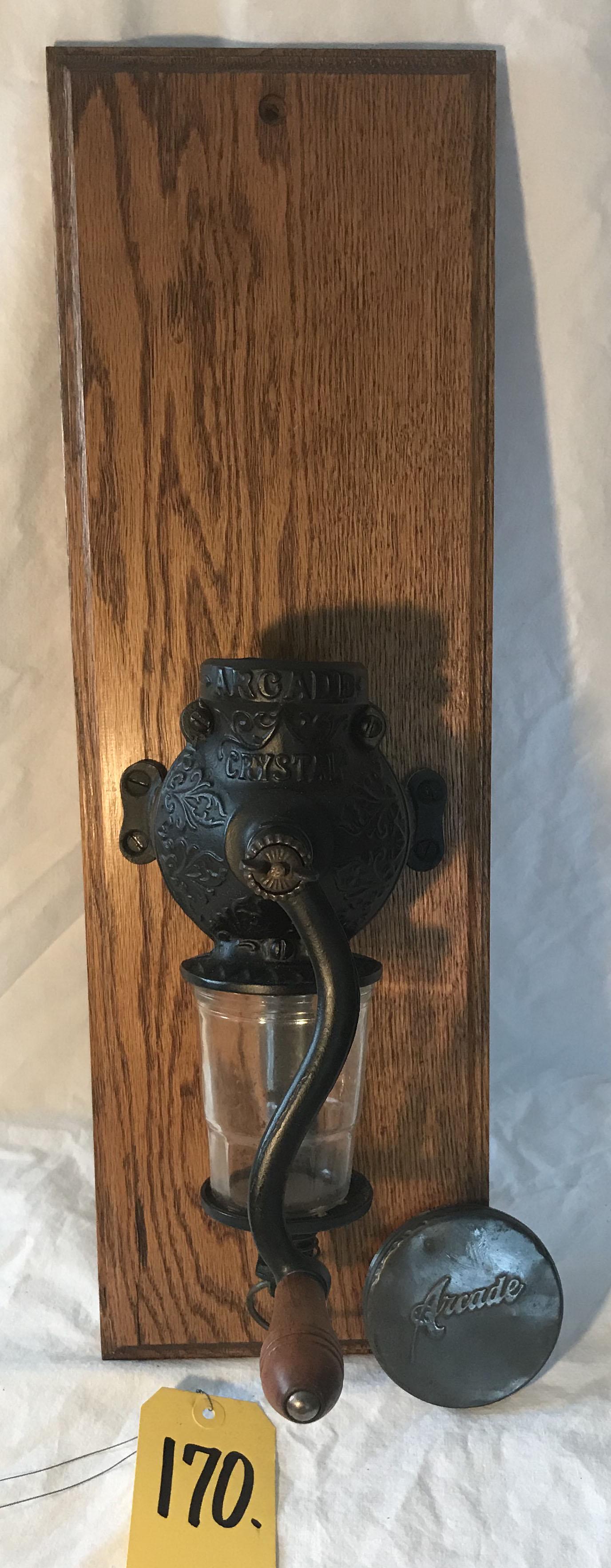Vintage Cast Iron Coffee Grinder: Vintage Arcade Crystal cast iron wall mounted coffee grinder, hand crank w/wooden handle, missing original top glass jar but tin lid included, bottom glass jar may be a later replacement, mounted on a