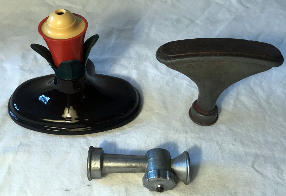 Grouping 3 Vintage Watering Devices: Grouping of 3 vintage watering devices: garden sprinkler w/yellow, red and green plastic flower form top on an oval earthenware base and black glaze, 5 1/4" T x 6 1/8" W x 3 5/8" D, marked on base w/3