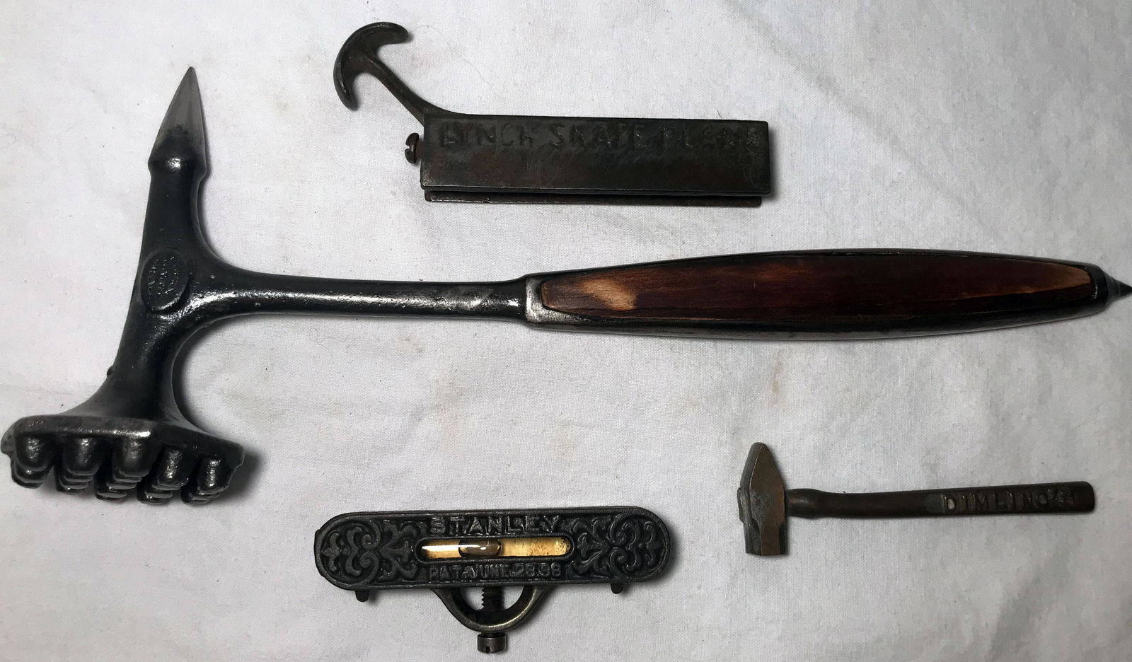 Vintage Tool/Utensil Lot: Vintage tool/utensil lot: an iron Lynch Skate Plane, pat. July 17th 1894, 1 5/8" T x 4 1/4" L x 1/2" W; Stanley cast iron level, 1 1/8" T x 3 1/8" L x 1/2" D; miniature sledge hammer, marked Dimling's
