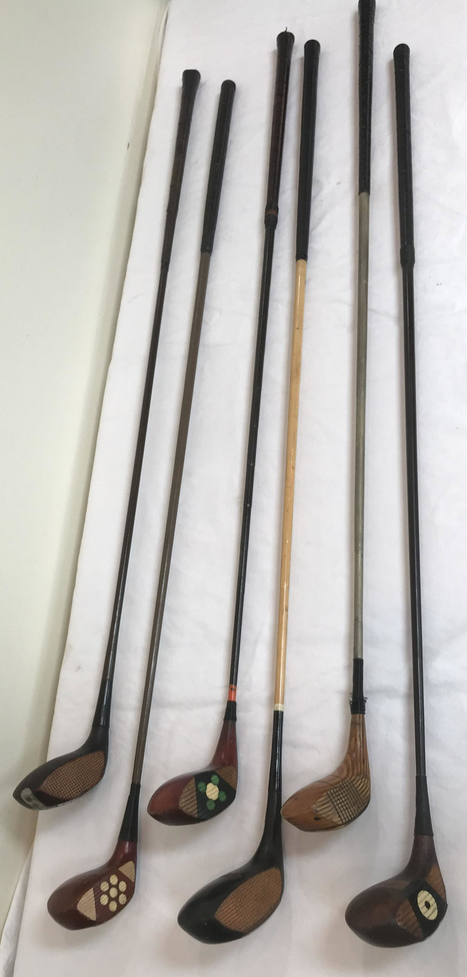 Grouping of 6 Vintage Golf Clubs: Grouping of 6 vintage golf clubs, all drivers w/wooden shafts: Wilson, 2 wood, M, 42"L; RAW MacGregor MM, 44 1/4" L-leather handle worn; MacGregor Dayton O Peerless Brassie, 43" L; Robert Jones, Jr.,