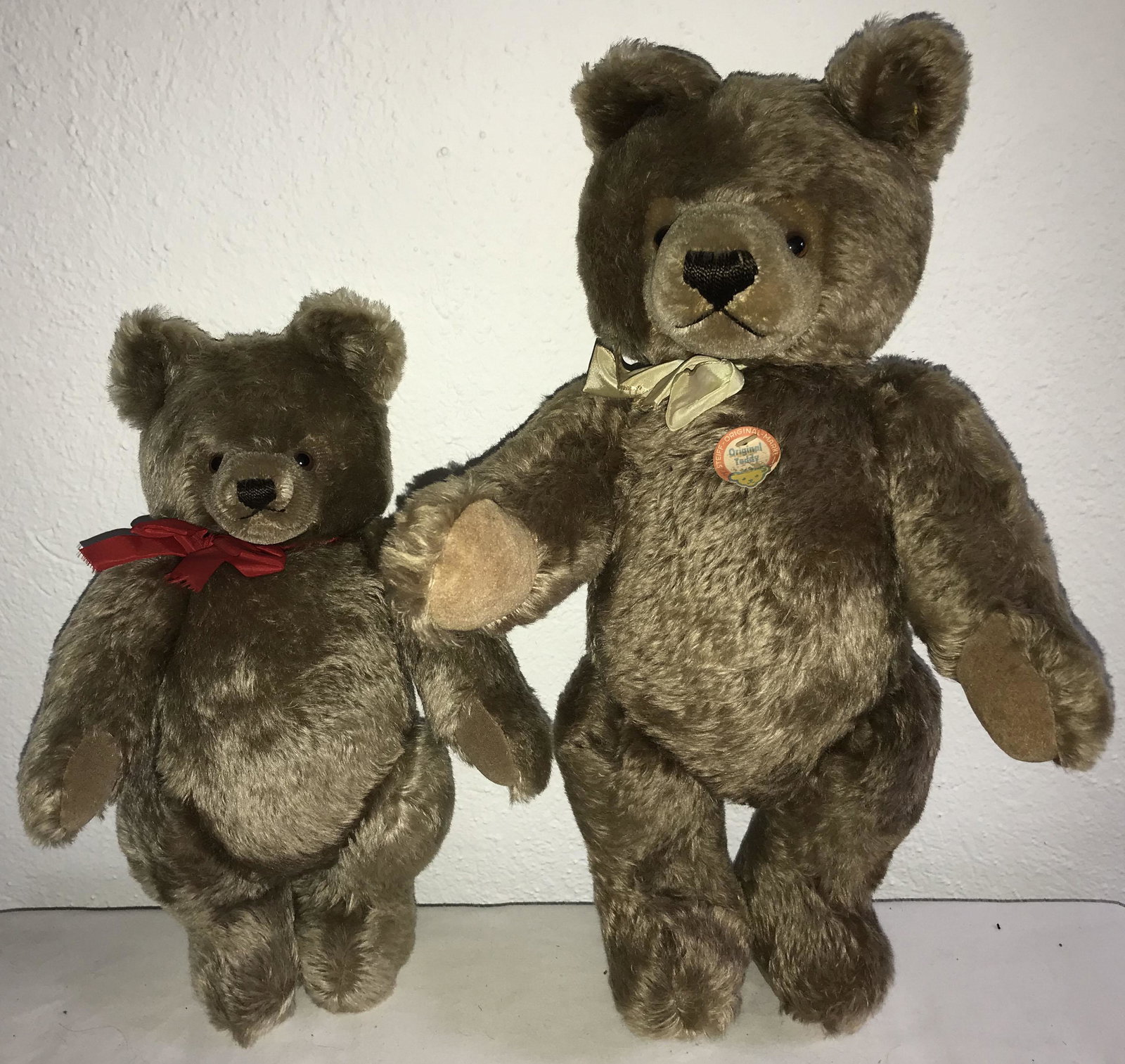 2 Steiff Teddy Bears: Grouping of (2) Steiff teddy bears: (1) w/Steiff-Original Marke tag, marked Original Teddy w/ear button and yellow tag-0202/51 Made in Germany, jointed body, glass eyes, ribbon soiled, chest tag soile