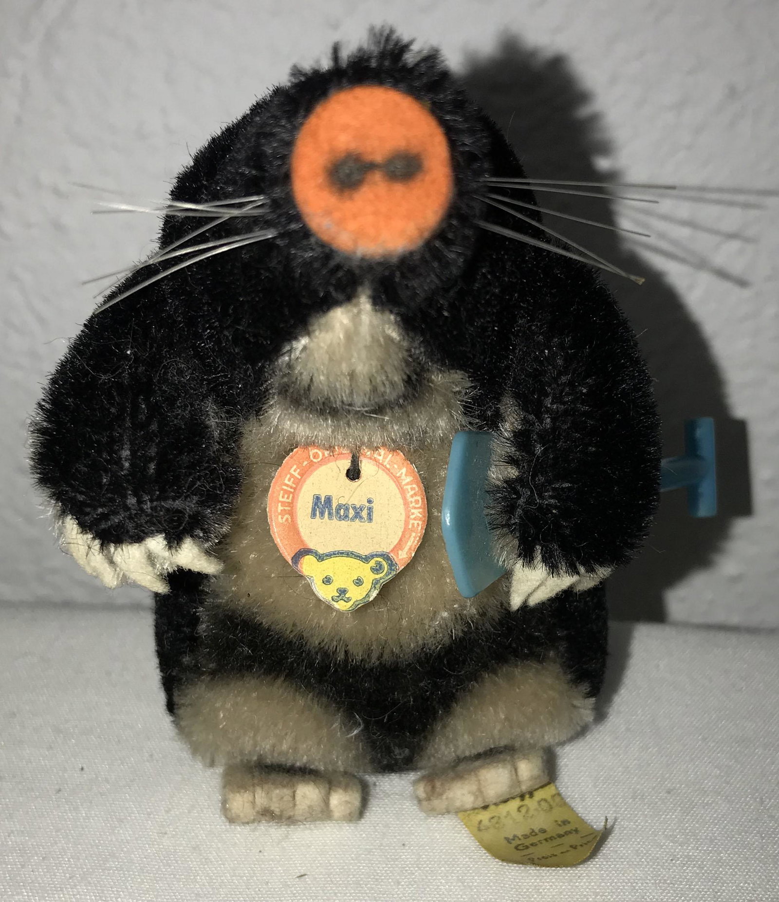 Steiff Mole: Steiff mole w/original paper tag marked Maxi, button and original yellow tag on left foot #4312/00 Made in Germany, w/"rare blue" shovel, tag shows some curling and discoloration on bottom, 4" T