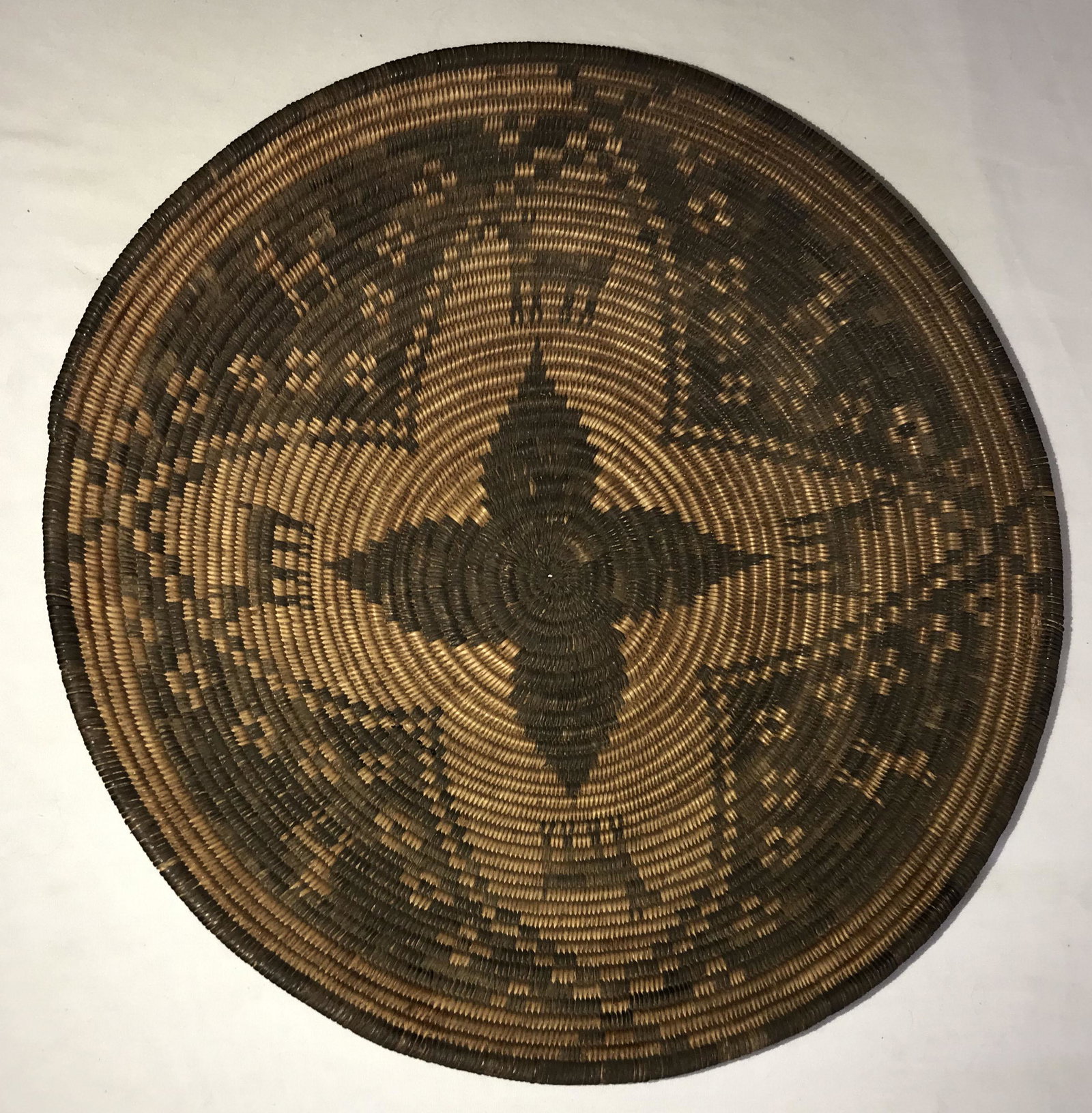 Vintage Native American Basket Bowl: Vintage Native American woven basket bowl, alternating tan and dark brown colors, base of the bowl has a dark "pinwheel" type design within a larger "pinwheel", 8 deer/stag form animal figures alterna