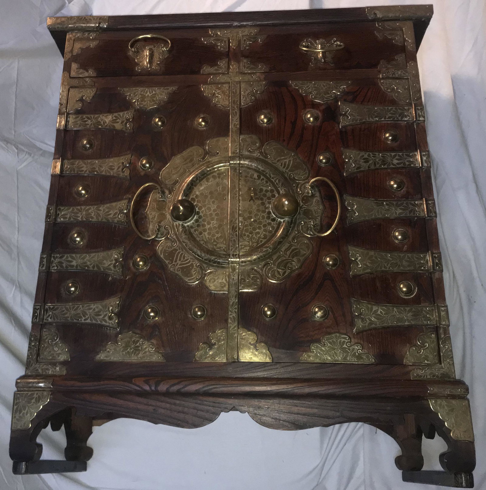 Vintage Asian Chest of Drawers: Vintage Asian chest of drawers, solid wood top and sides having 2 half width drawers over 2 bland doors opening to a full width drawer, 2 half width drawers and 3 one-third width drawers on a base w/c