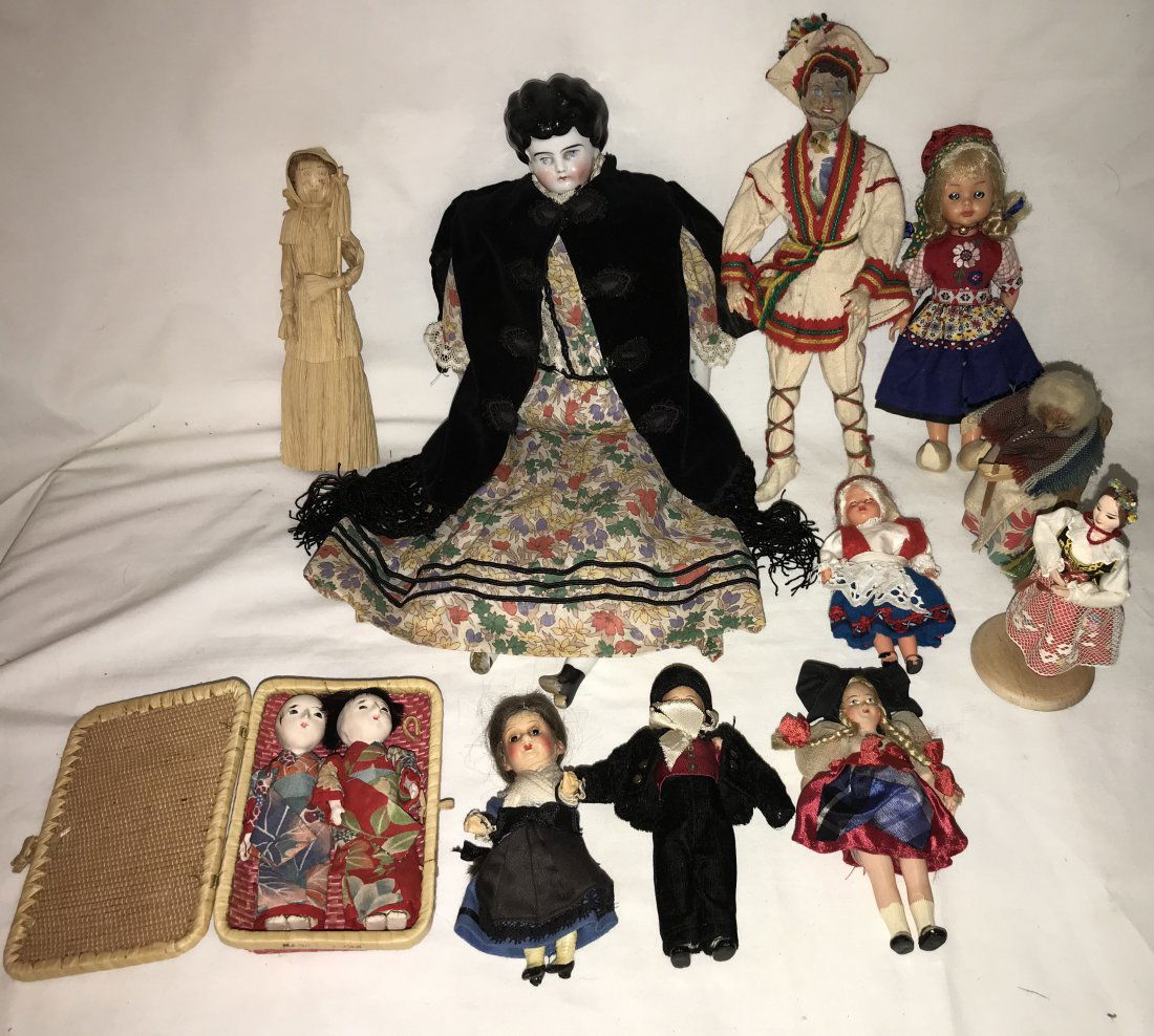 Grouping of Assorted Dolls: Grouping of 11 Dolls: (2) Geisha in woven box, appear to be paper mache (?) in Japanese dress; celluloid w/blond hair in Swiss attire-no mark visible; corn husk; doll w/what appears to be a nut head,