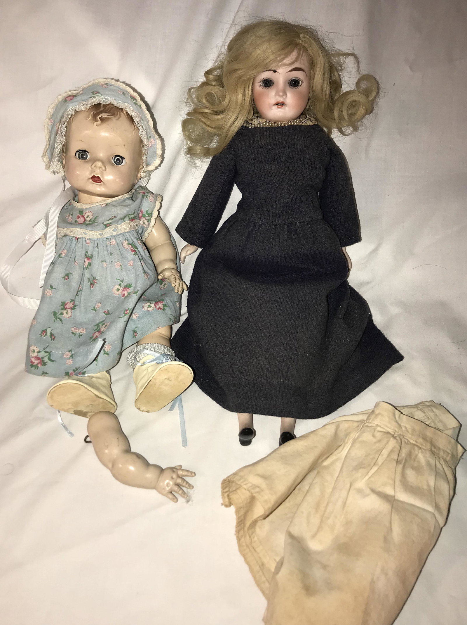 Lot of 2 Dolls: Lot of 2 Dolls: porcelain head doll w/cloth (cotton) body, handpainted facial feathers, sleeping eyes, open mouth showing teeth, hair may be replacement, mead marked "Darlington 9/0", homemade blue dr