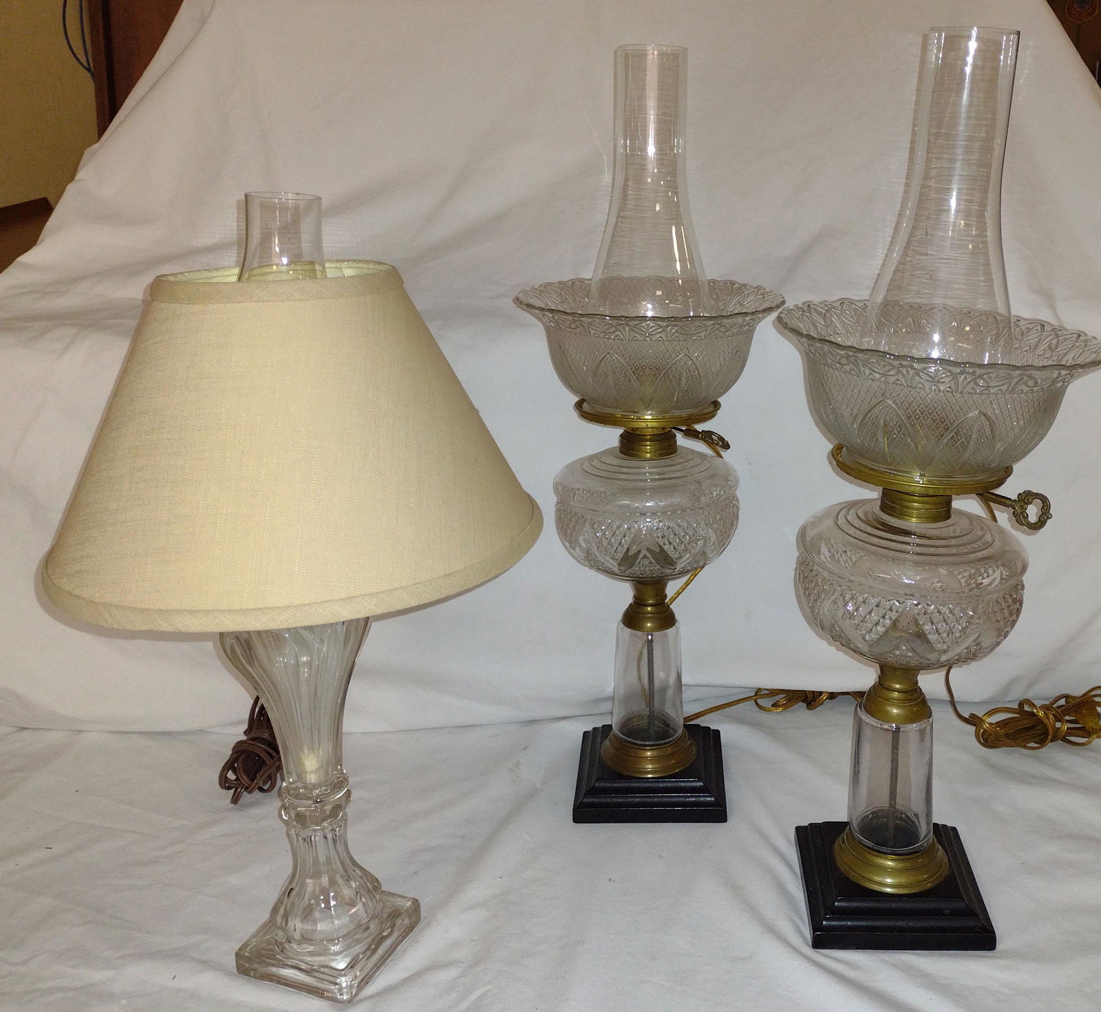 Grouping of Vintage Lamps: Vintage flint type clear glass whale oil lamp w/loop design ending on a square base, good condition, electrified, 12" T (original height) AND a pair of matching clear pattern glass lamps w/round shade