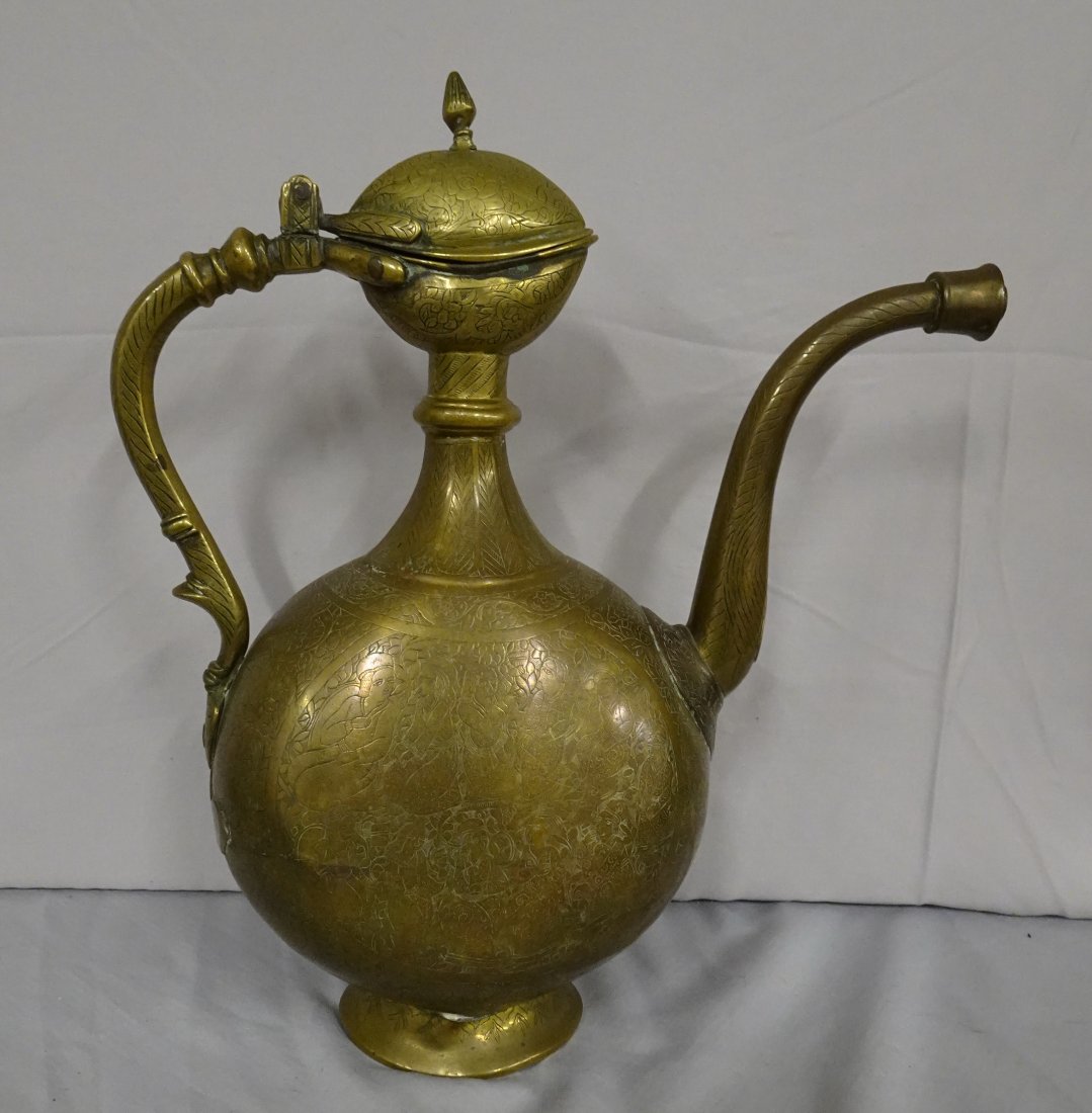 ANTIQUE ISLAMIC BRASS EWER WINE POT: Islamic ewer,dated 1709 at base of the spout-The back of the pot contains writing in Arabic script reading: Belonging to Master----name is very hard to read-21 human figures surround the sides-One den