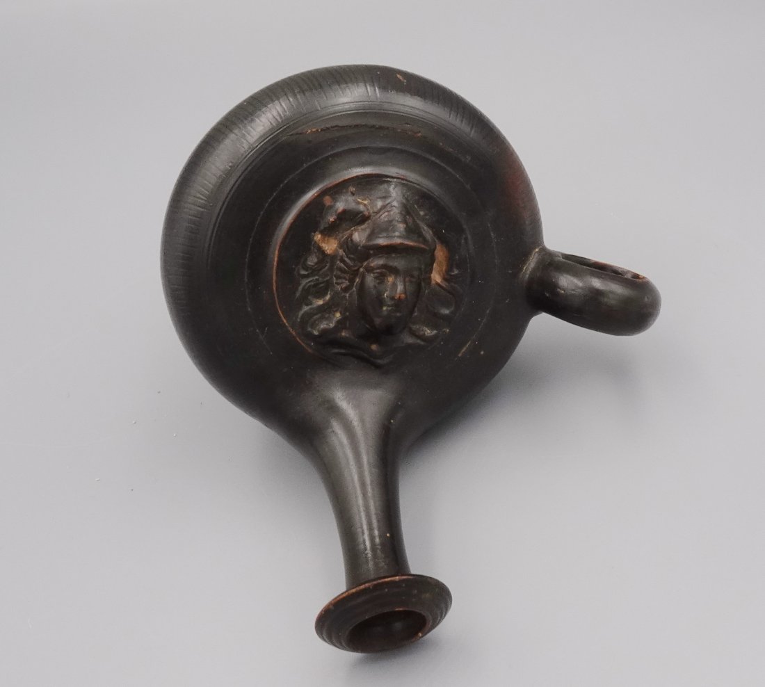 ANCIENT GREEK BLACKWARE OIL LAMP FILLER GUTTOS: A great example of a Very Early Greek(third century) ceramic guttus (also guttos) used to pour oil into oil-burning lamps. The vessel rests upon a concave ringed foot with a discoid body covered in do