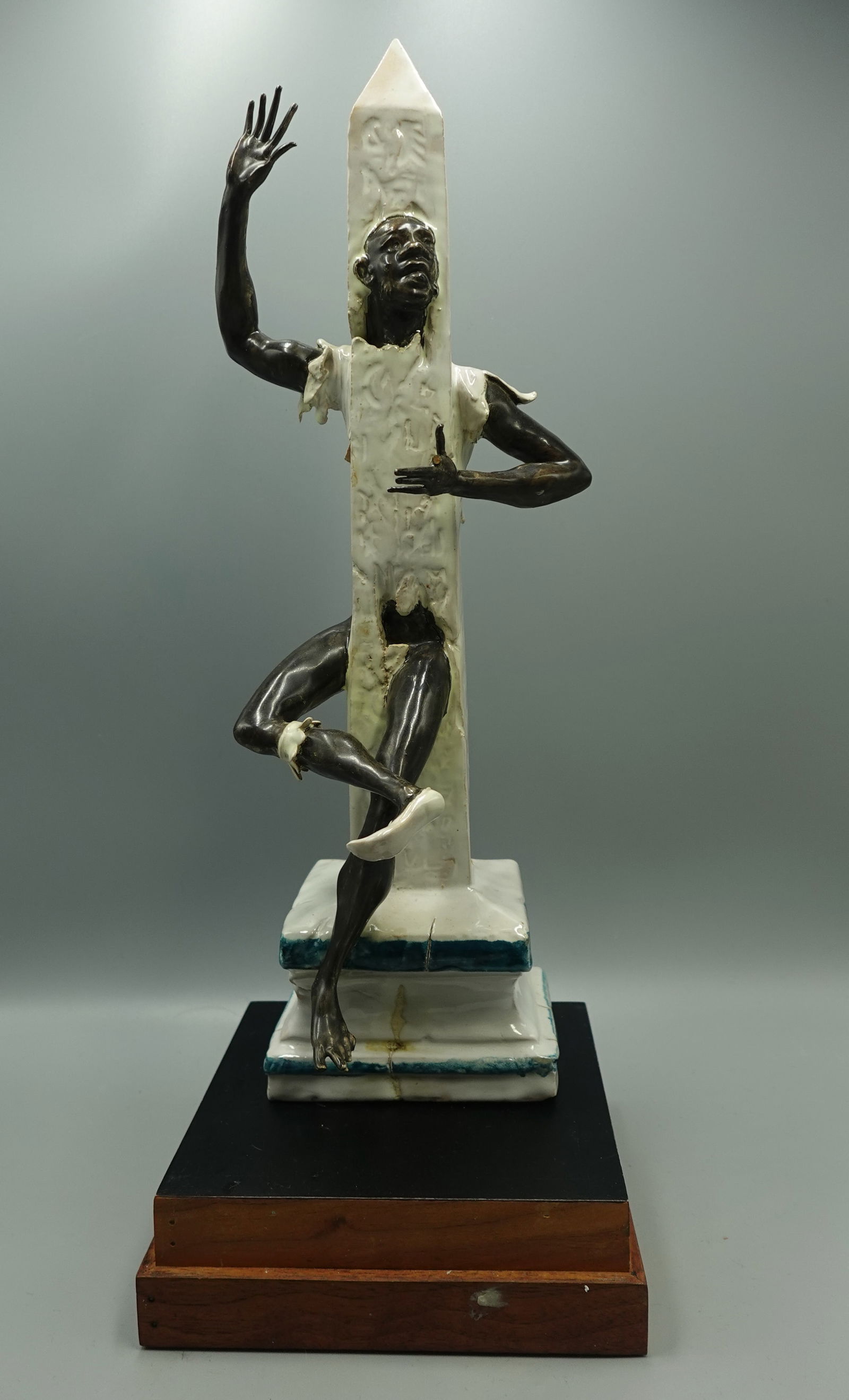 RARE IMPORTANT ANDREA SPADINI (ITALIAN 1912-1983) -PORCELAIN SCULPTURE STATUE: RARE LISTED ARTIST ANDREA SPADINI GLAZED PORCELAIN BLACKAMOOR SCULPTURE ON OBELISK (ITALIAN, ROME 1912-1983)-On stand under lucite box-Overall good condition with one fragile finger broken that is int