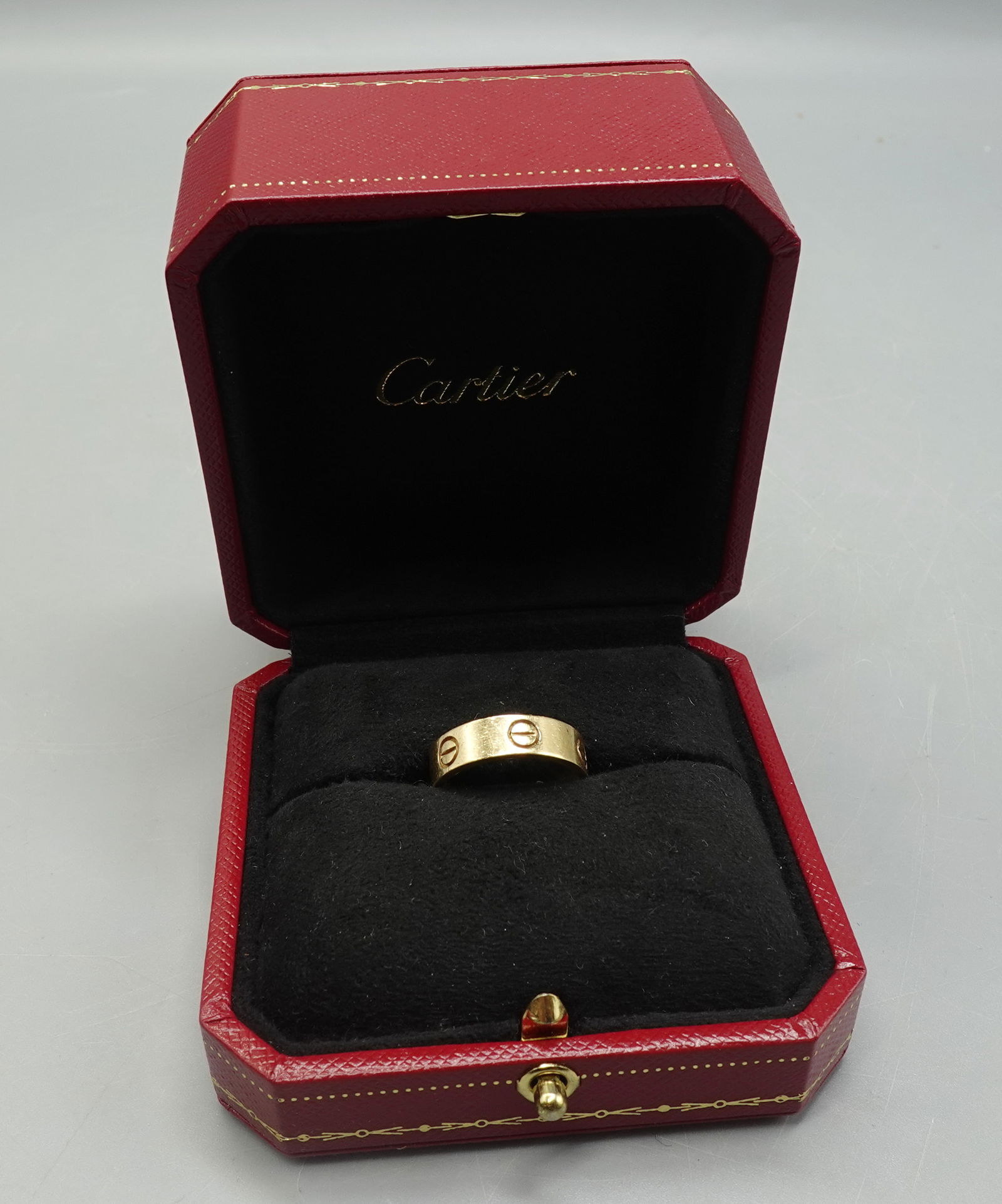 CARTIER LOVE RING 18K 750 YELLOW GOLD WITH BOX: CARTIER LOVE RING 18K 750 YELLOW GOLD WITH BOX RING SIZE Eur 53/6.25 US -good preowned condition with surface scratches--Provenance: From the Estate of Barbara Kanash art dealer and collector --Saddle