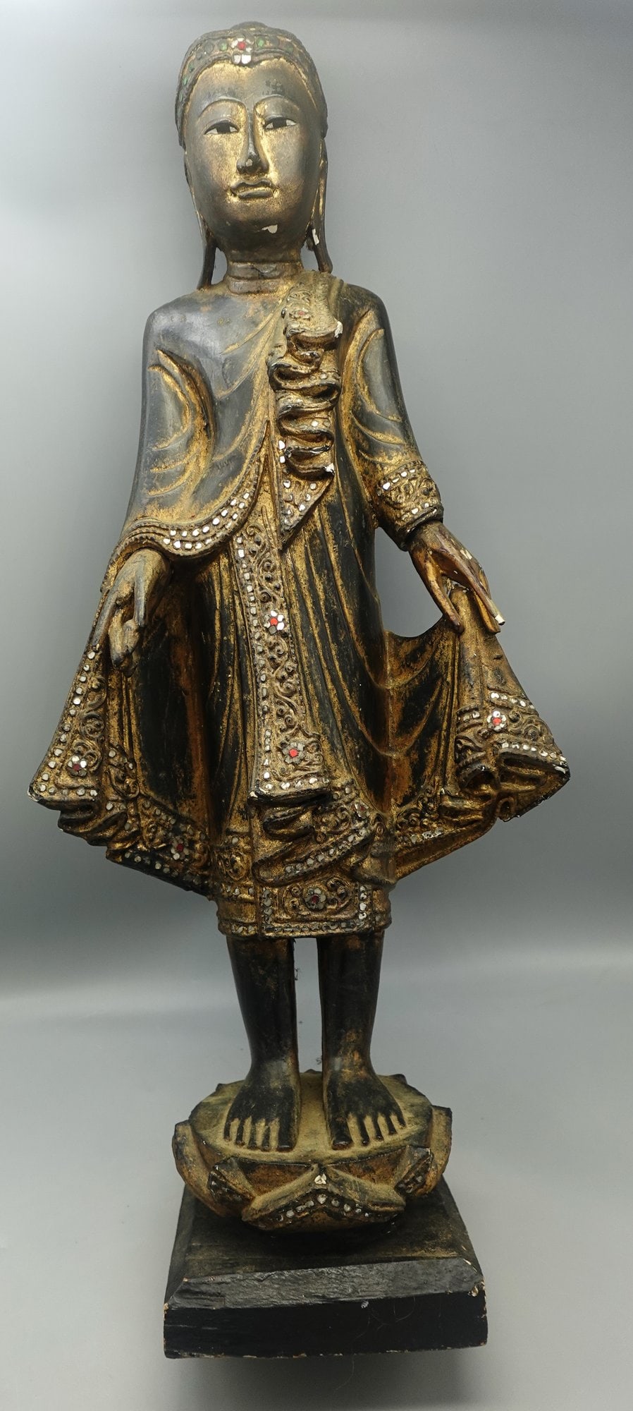 ANTIQUE BURMESE WOOD BUDDHA ATOP LOTUS FLOWER: Antique 19/18c Burmese wood Buddha atop a lotus flower with gilding and glass inlay-some gilding loss and overall age related wear but overall remaining in good antique condition-Measures 26" tall--- 