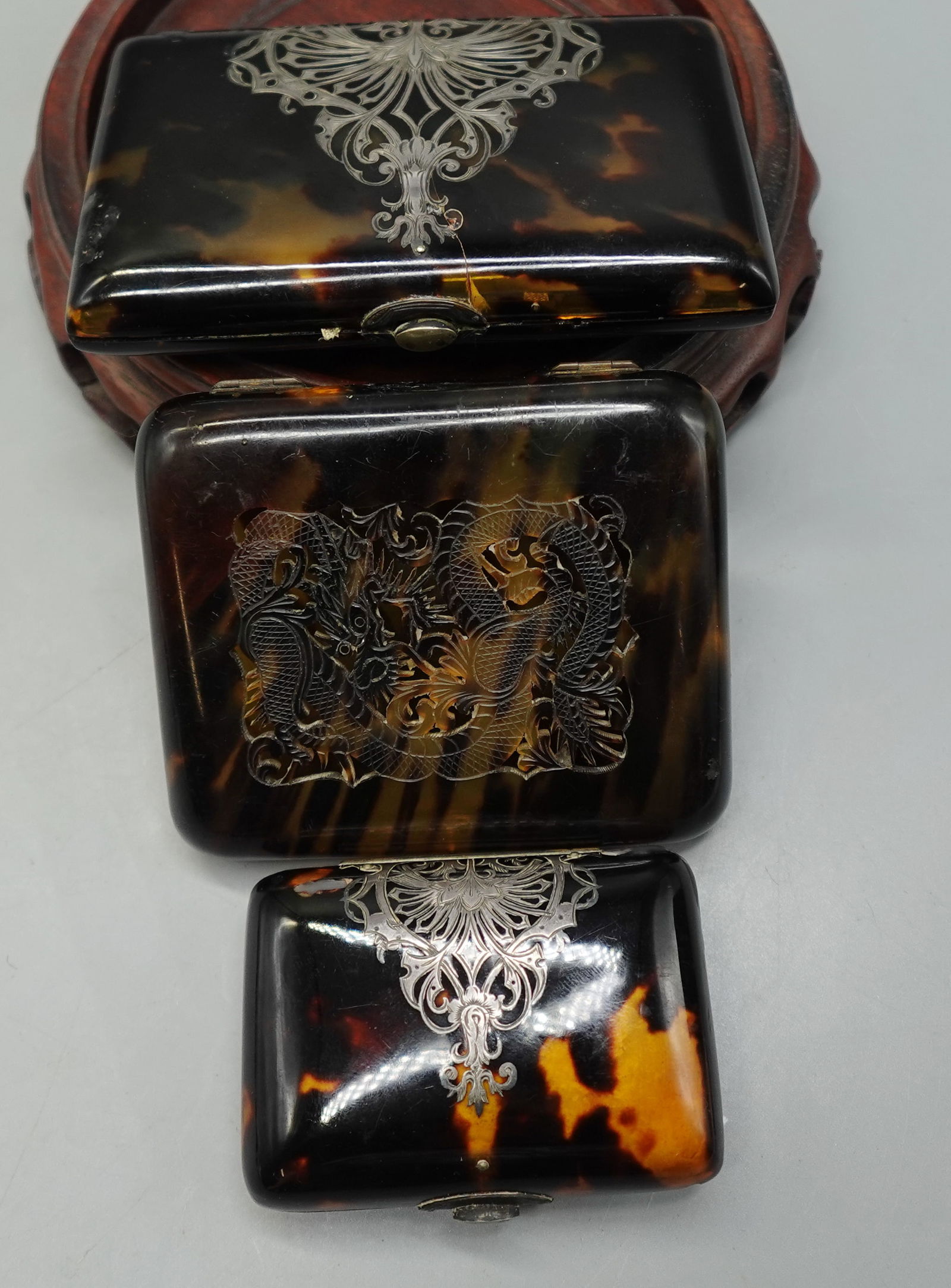 THREE ANTIQUE FRENCH BREVETE BAKELITE TORTOISE COIN CIGARETTE CASE: A beautiful lot of antique coin and cigarette case-one Bakelite coin case with beautiful silver detailing and satin interior marked on inside Brevete-one tortoise and fine silver detailing cigarette c