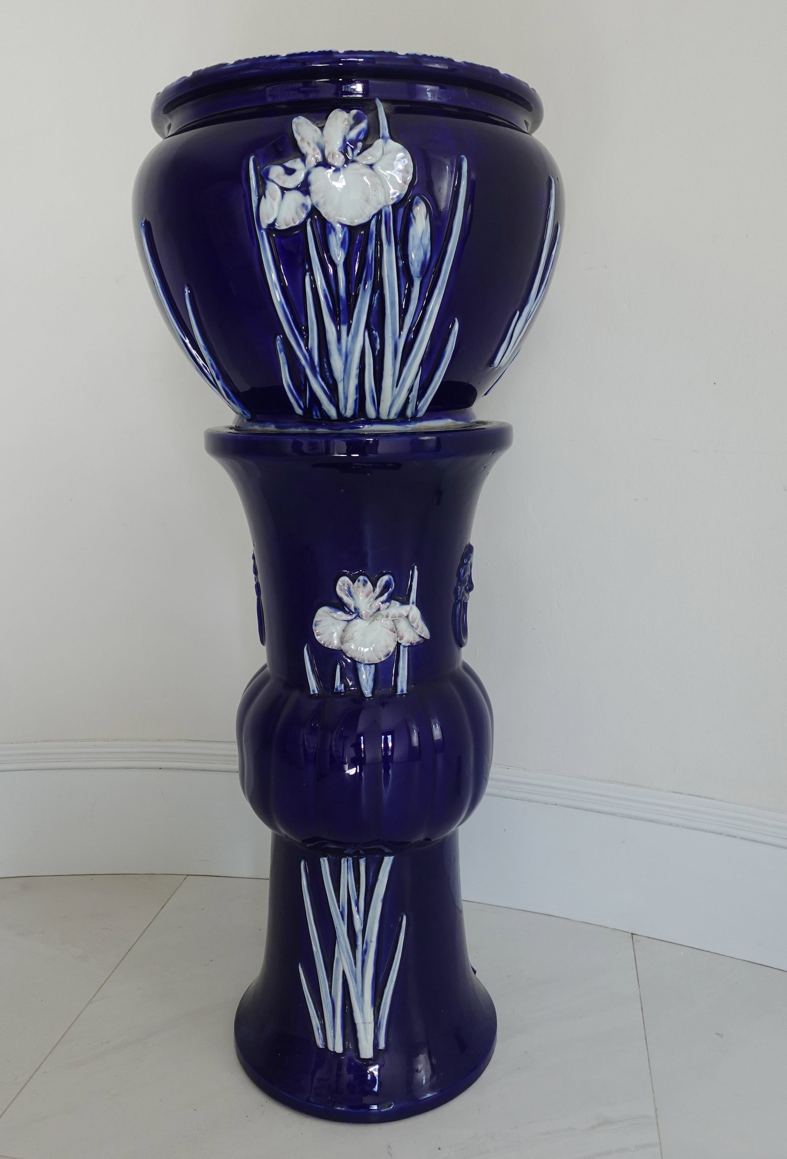 ANTIQUE COBALT BLUE ART NOUVEAU JAPANESE JARDINIERE ON PEDESTAL: Cobalt blue majolica possibly Japanese jardinière on pedestal with iris design and two open mouth foo dog handles at sides- 13" diameter bowl; 36 1/2" H. Circa late 19th - early 20th century. Excelle