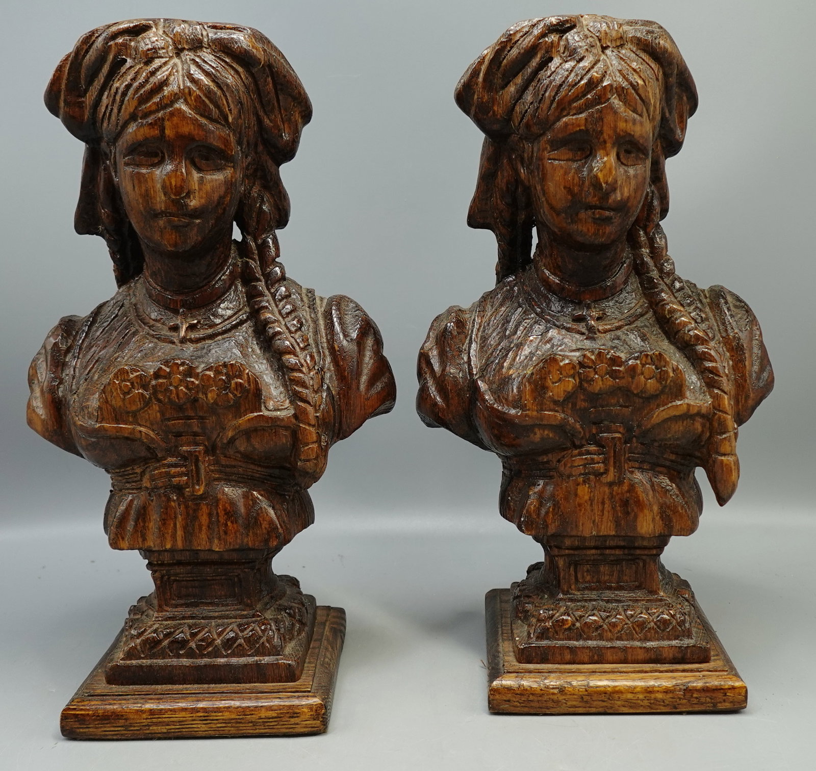 PAIR OF EUROPEAN FOLK ANTIQUE HAND CARVED WOODEN BUST SCULPTURE OF WOMAN: A pair of 19c wooden busts depicting woman in traditional clothing and hairstyle with cross around neck-Most likely European --measures 12" tall and remains in good antique condition--ALL MEDIUM AND S
