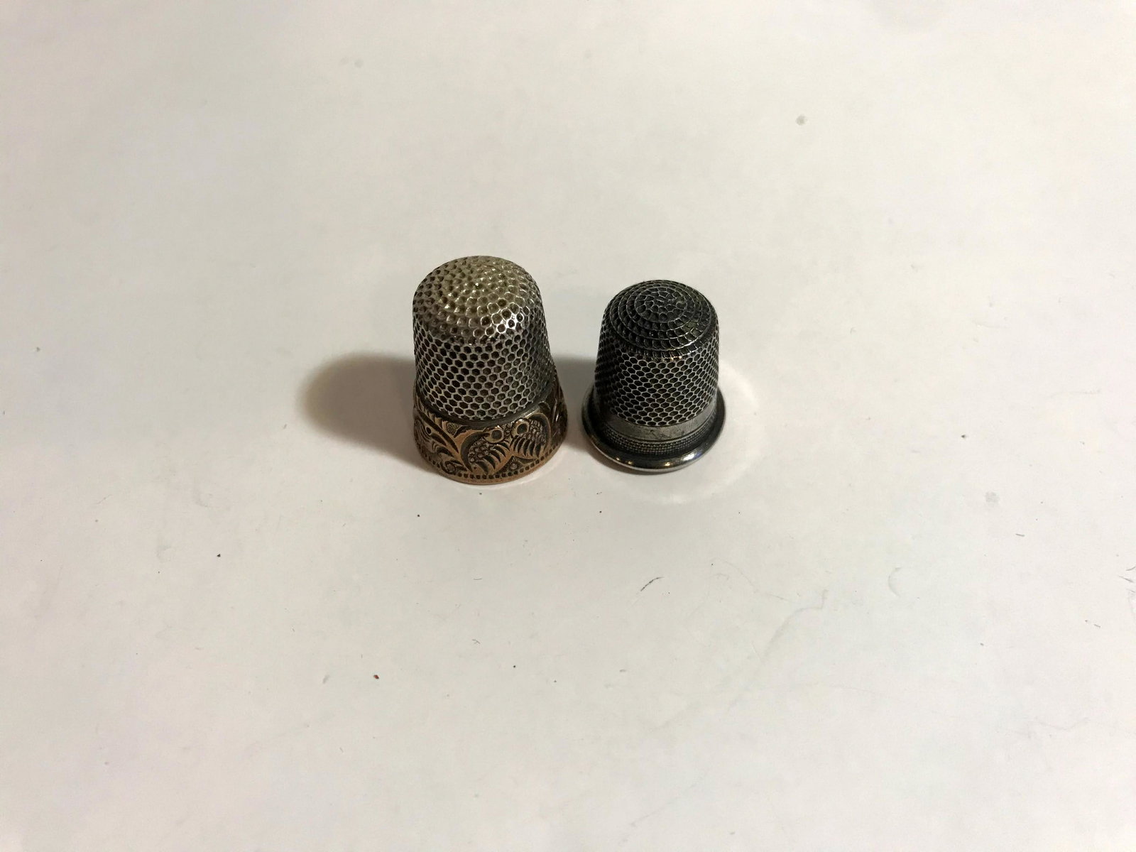 A lot of two sewing thimbles 1 Sterling & 14k: A lot of two sewing thimbles 1 Sterling & 14k Please view all photos as they are part of the description and condition of this Item, Feel free to contact me with questions or picture requests!. Used I
