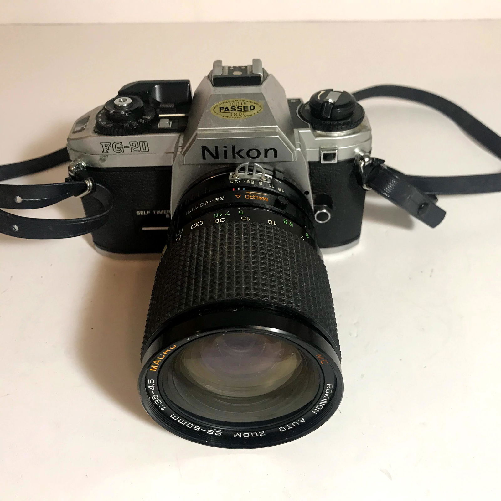 Nikon FG-20 35mm SLR Film Camera with rokinon lens: Please view all photos as they are part of the description and condition of this Item, Feel free to contact me with questions or picture requests!. Working Used Item AS IS