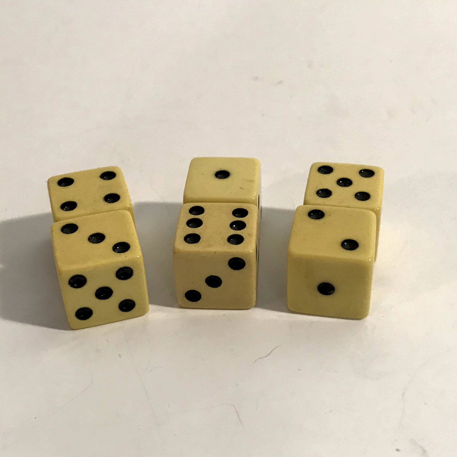 Six Vintage Bakalite Dice: Six Vintage Bakalite Dice Please view all photos as they are part of the description and condition of this Item, Feel free to contact me with questions or picture requests!