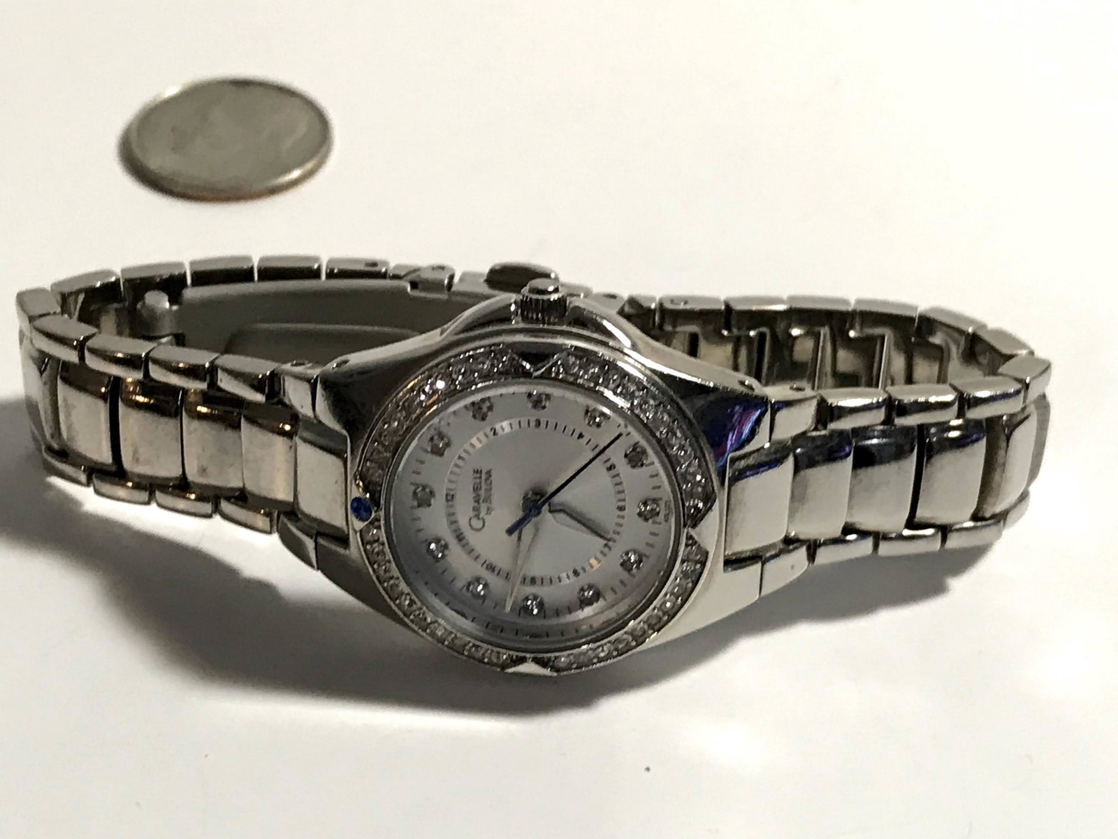 Caravelle by Bulova Ladies ,crystal bezel Watch Working: Caravelle by Bulova Ladies ,crystal bezel Watch signed on the back Please view all photos as they are part of the description and condition of this Item, Feel free to contact me with questions or pict