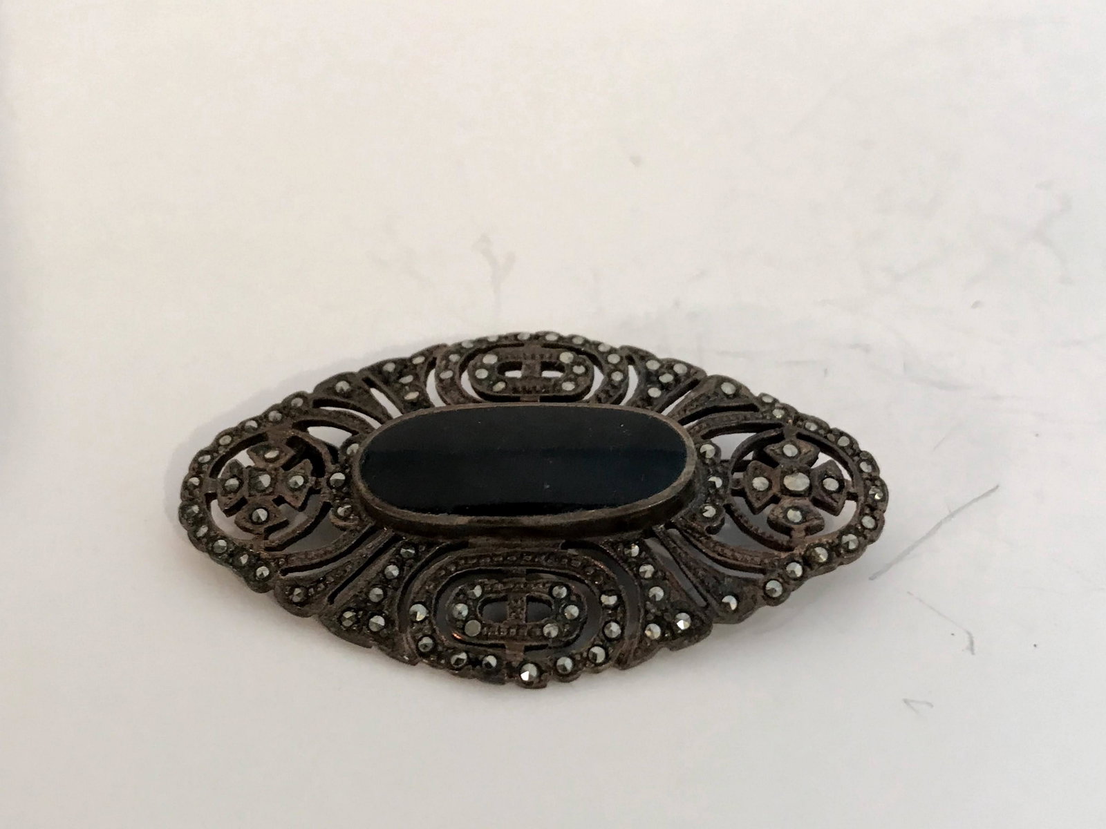 Vintage Sterling Silver Marcasite and Onyx Brooch: Vintage Marcasite and Onyx Brooch Please view all photos as they are part of the description and condition of this Item, Feel free to contact me with questions or picture requests! Used Item AS IS