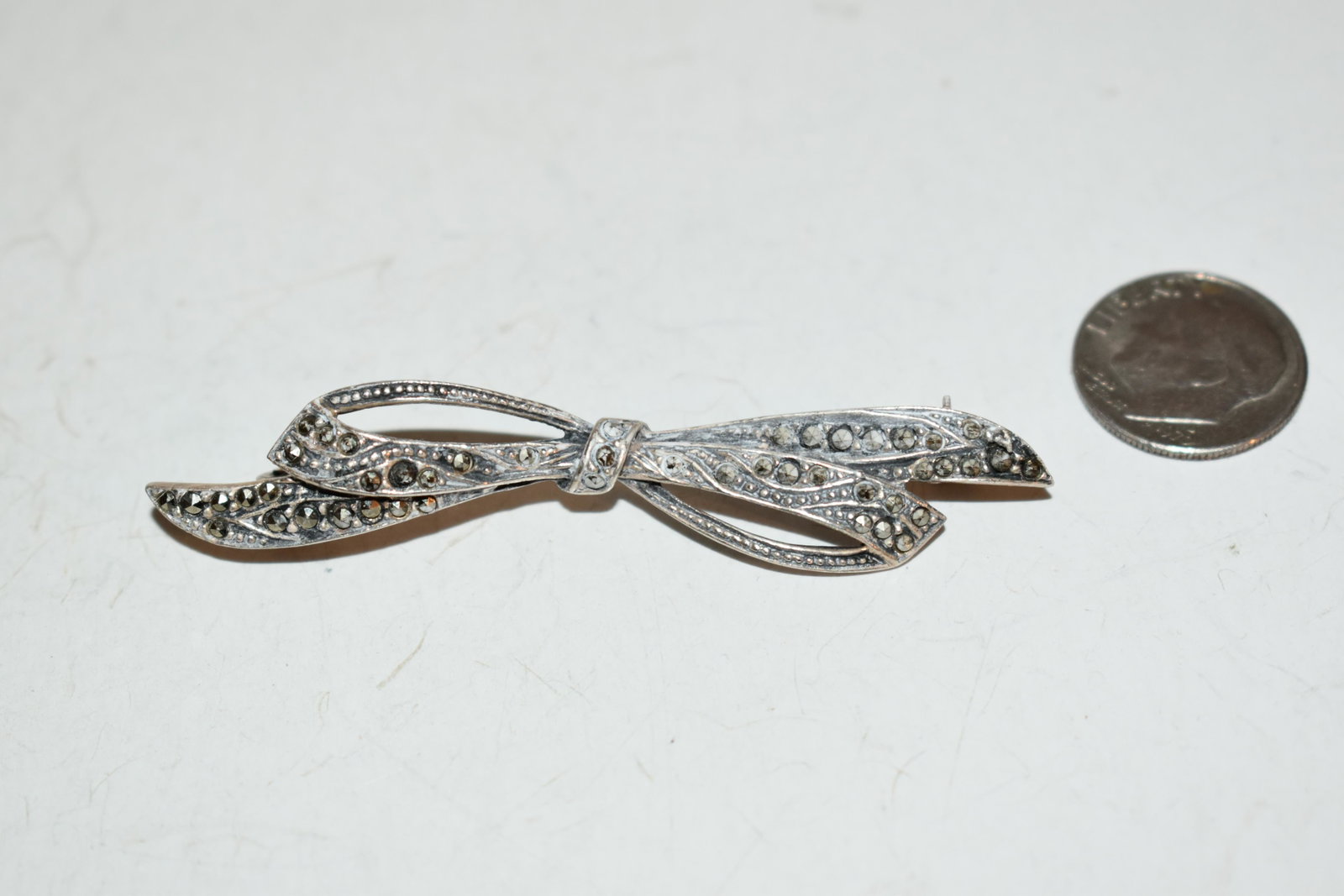 Vintage Sterling Silver marcasite bow brooch Brooch 2 1/2": Vintage Sterling Silver marcasite bow brooch Brooch 2 1/2" Please view all photos as they are part of the description and condition of this Item, Feel free to contact me with questions or picture requ