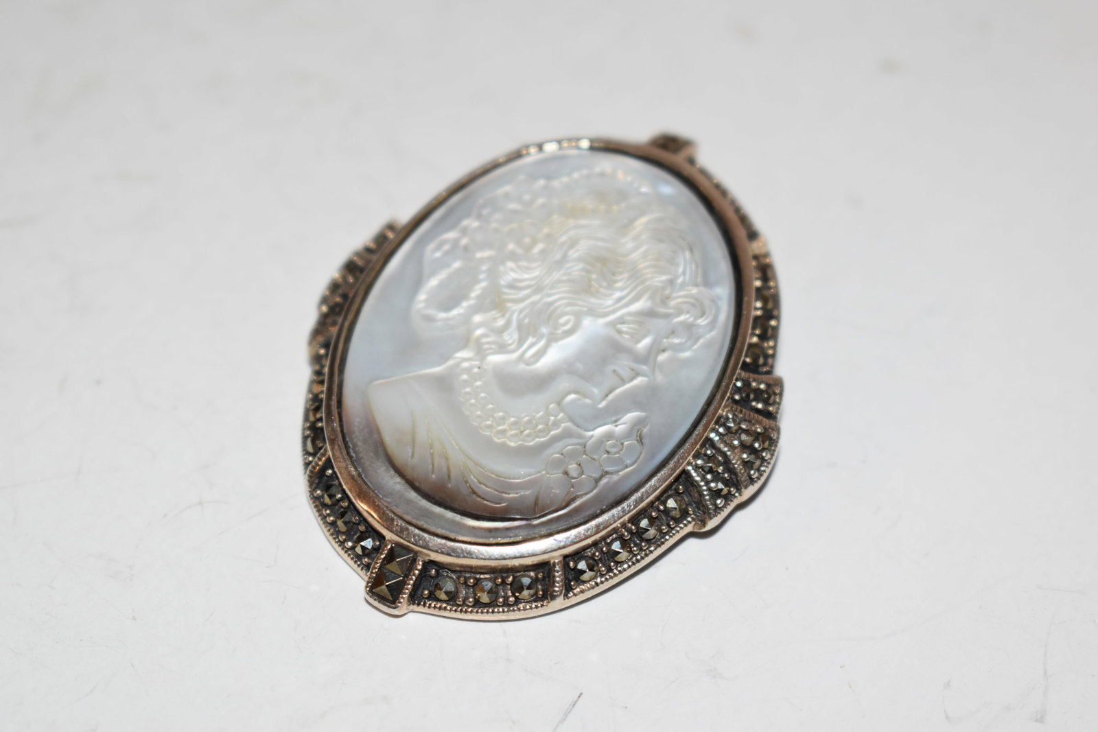 Rare Vintage Mother-of-Pearl Marcasite Cameo Sterling Silver Pendant / Brooch 2": Rare Vintage Mother-of-Pearl Marcasite Cameo Sterling Silver Pendant / Brooch 2" Please view all photos as they are part of the description and condition of this Item, Feel free to contact me with que