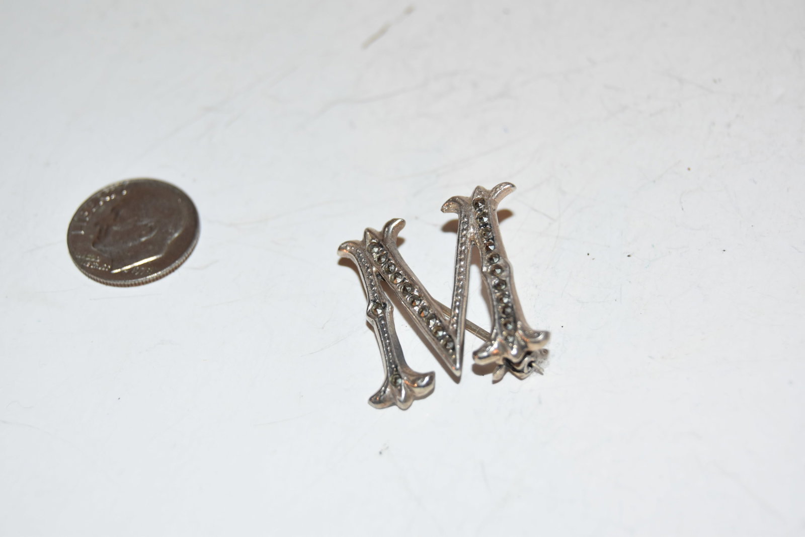 Vintage Sterling Silver M MARCASITE Brooch: Vintage Sterling Silver M MARCASITE Brooch Please view all photos as they are part of the description and condition of this Item, Feel free to contact me with questions or picture requests! Used Item 