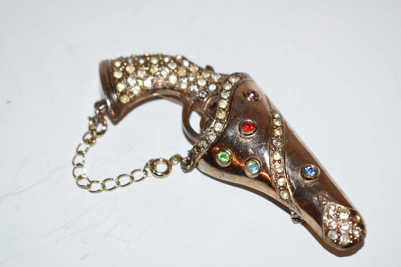 Vintage Rare Unsigned Coro Gold tone Gun Holester rhinestone pin brooch: Vintage Rare Unsigned Coro Gold tone Gun Holester rhinestone pin brooch Please view all photos as they are part of the description and condition of this Item, Feel free to contact me with questions or