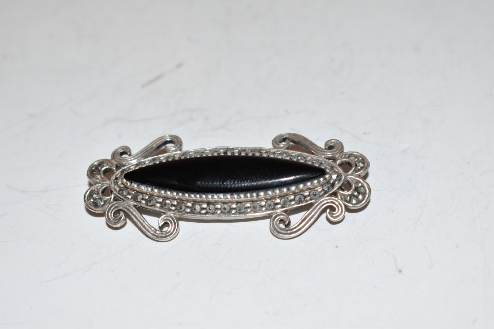 Vintage Sterling Silver onyx marcasite Brooch: Vintage Sterling Silver onyx marcasite Brooch Please view all photos as they are part of the description and condition of this Item, Feel free to contact me with questions or picture requests! Used It