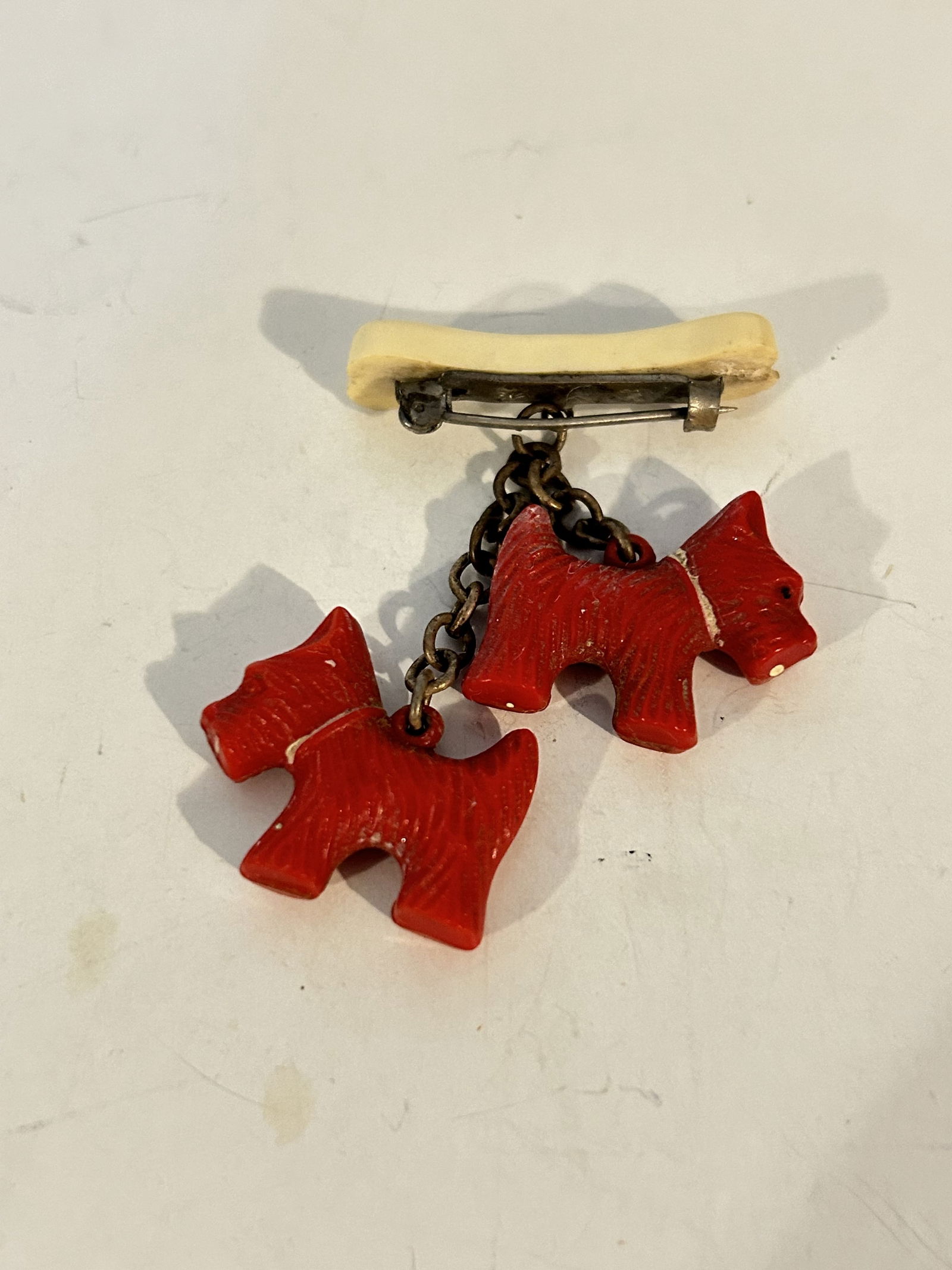 Vintage bakelite dogs and bone pin Brooch: Vintage bakelite dogs and bone pin Brooch Please view all photos as they are part of the description and condition of this Item, Feel free to contact me with questions or picture requests! Used Item A