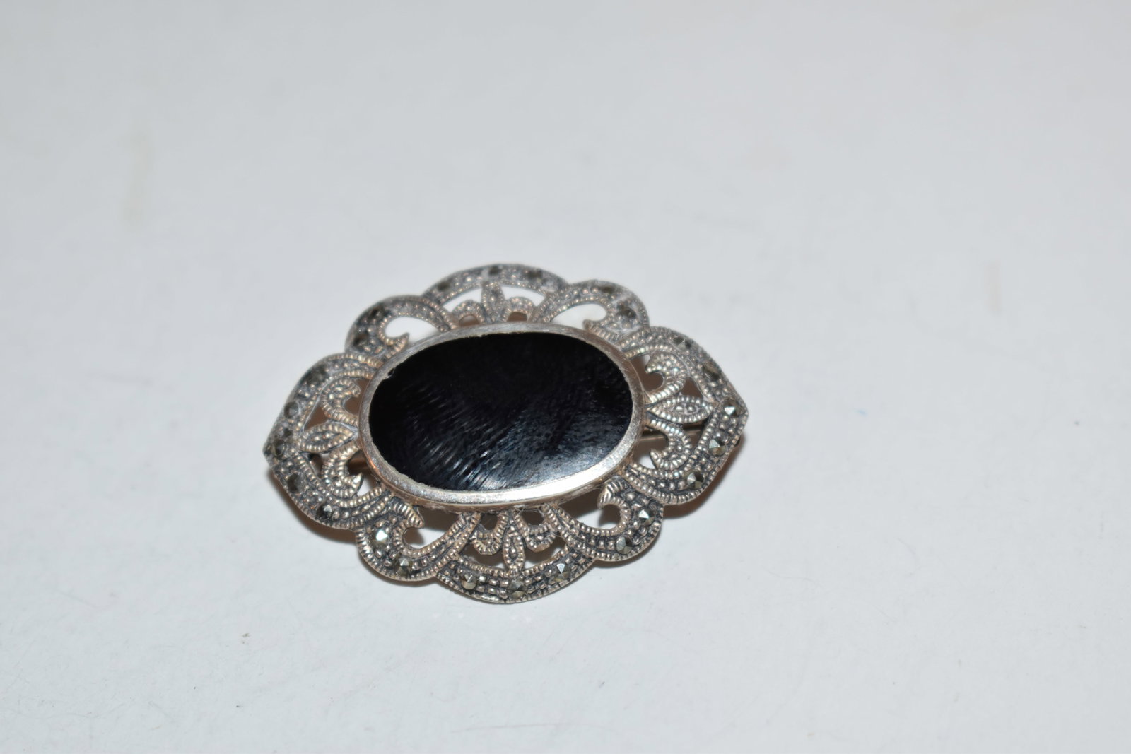 Vintage Sterling Silver marcasite onyx Brooch: Vintage Sterling Silver marcasite onyx Brooch Please view all photos as they are part of the description and condition of this Item, Feel free to contact me with questions or picture requests! Used It