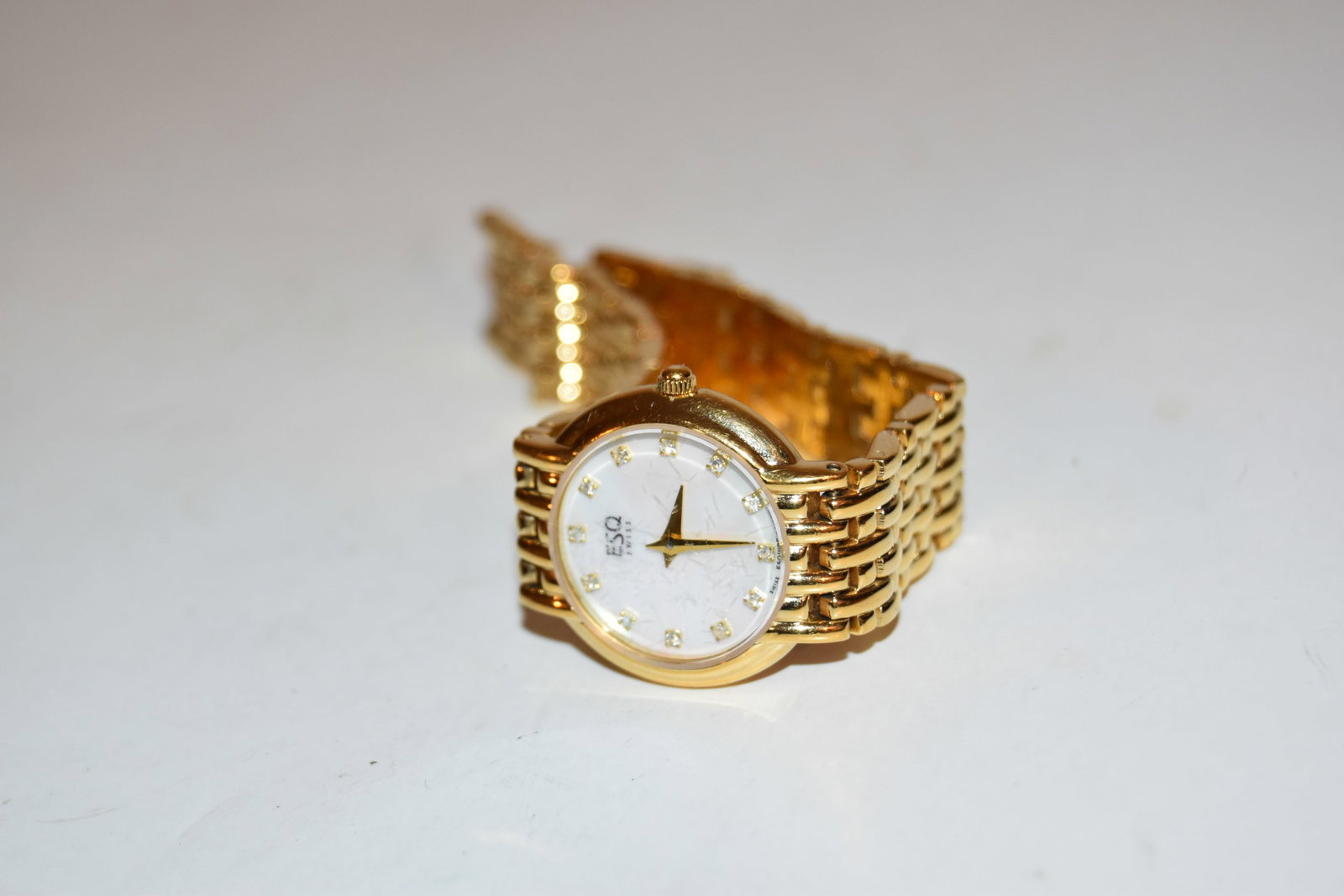 ESQ Swiss Watch Women Gold Tone pearl Dial works great!!! Has light scratches to the face: ESQ Swiss Watch Women Gold Tone pearl Dial works great!!! Has light scratches to the face Please view all photos as they are part of the description and condition of this Item, Feel free to contact me