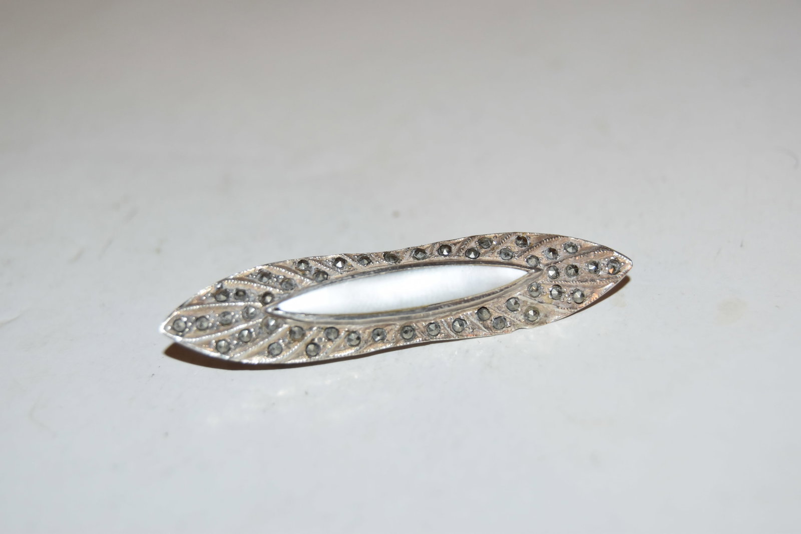 Vintage Sterling Silver mother of pearl marcasite brooch: Vintage Sterling Silver mother of pearl marcasite brooch Please view all photos as they are part of the description and condition of this Item, Feel free to contact me with questions or picture reques