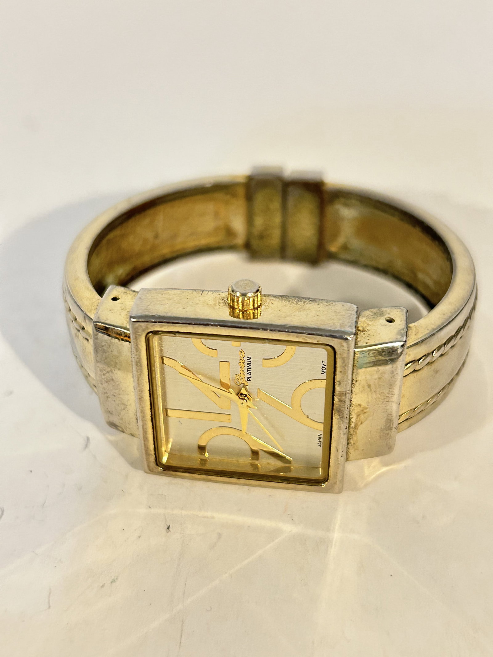 Vintage Geneva Platinum Hinged Cuff Watch works great!!!: Vintage Geneva Platinum Hinged Cuff Watch works great!!! Please view all photos as they are part of the description and condition of this Item, Feel free to contact me with questions or picture reques