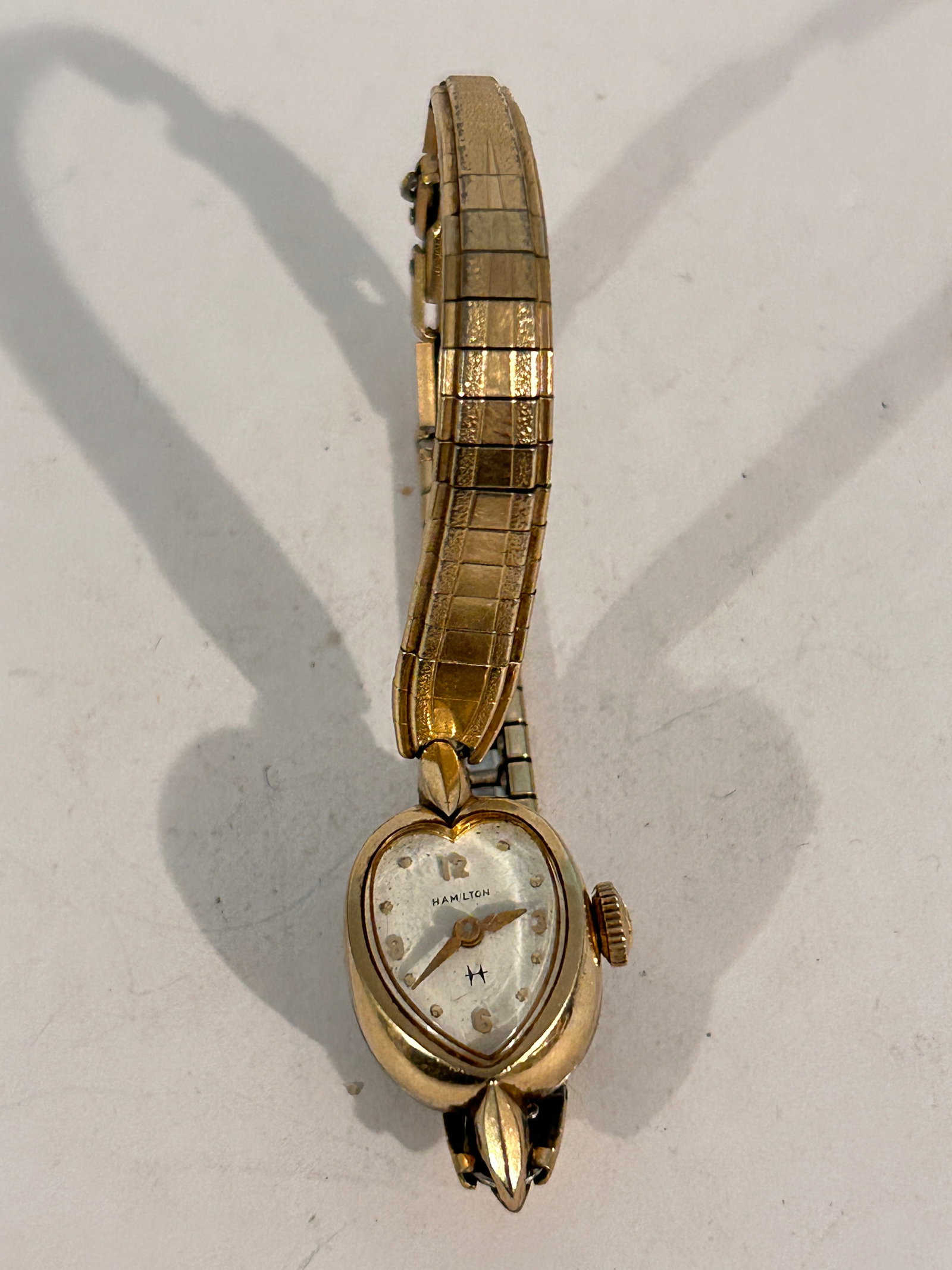 Vtg Hamilton 10k Gold Filled Ladies Heart Watch working: Vtg Hamilton 10k Gold Filled Ladies Heart Watch working Please view all photos as they are part of the description and condition of this Item, Feel free to contact me with questions or picture request